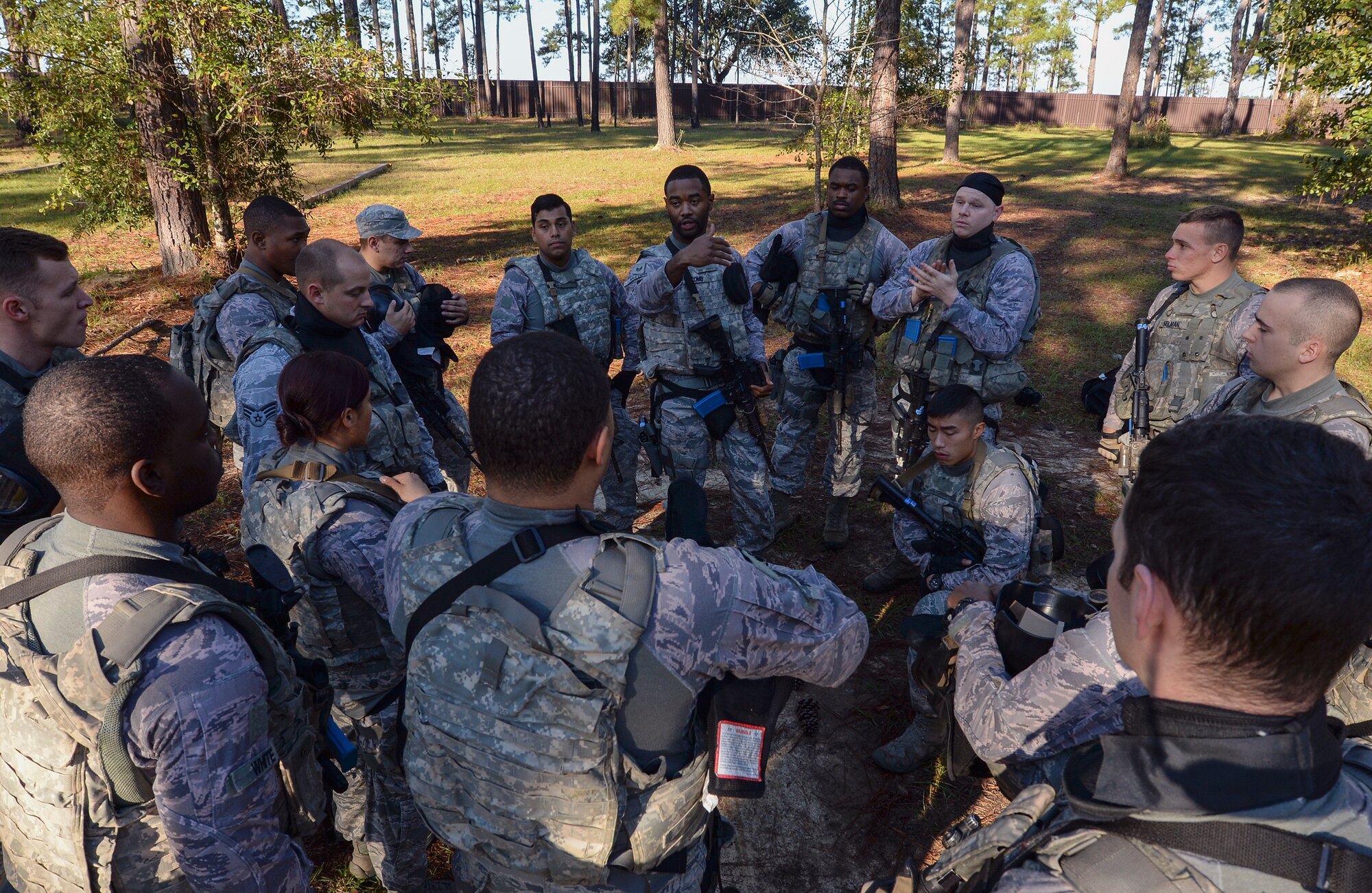 U.S. Air Force Staff Sgt. Marcus McComb, 822d Base Defense Squadron fire team leader, briefs Airmen on their mission during a force-on- force training exercise at the military operations in urban terrain village, Dec. 10, 2015, at Moody Air Force Base, Ga. McComb strategically divided his squad into smaller units with different objectives and instructed them to work together to accomplish the mission. (U.S. Air Force photo by Airman 1st Class Janiqua P. Robinson/Released)