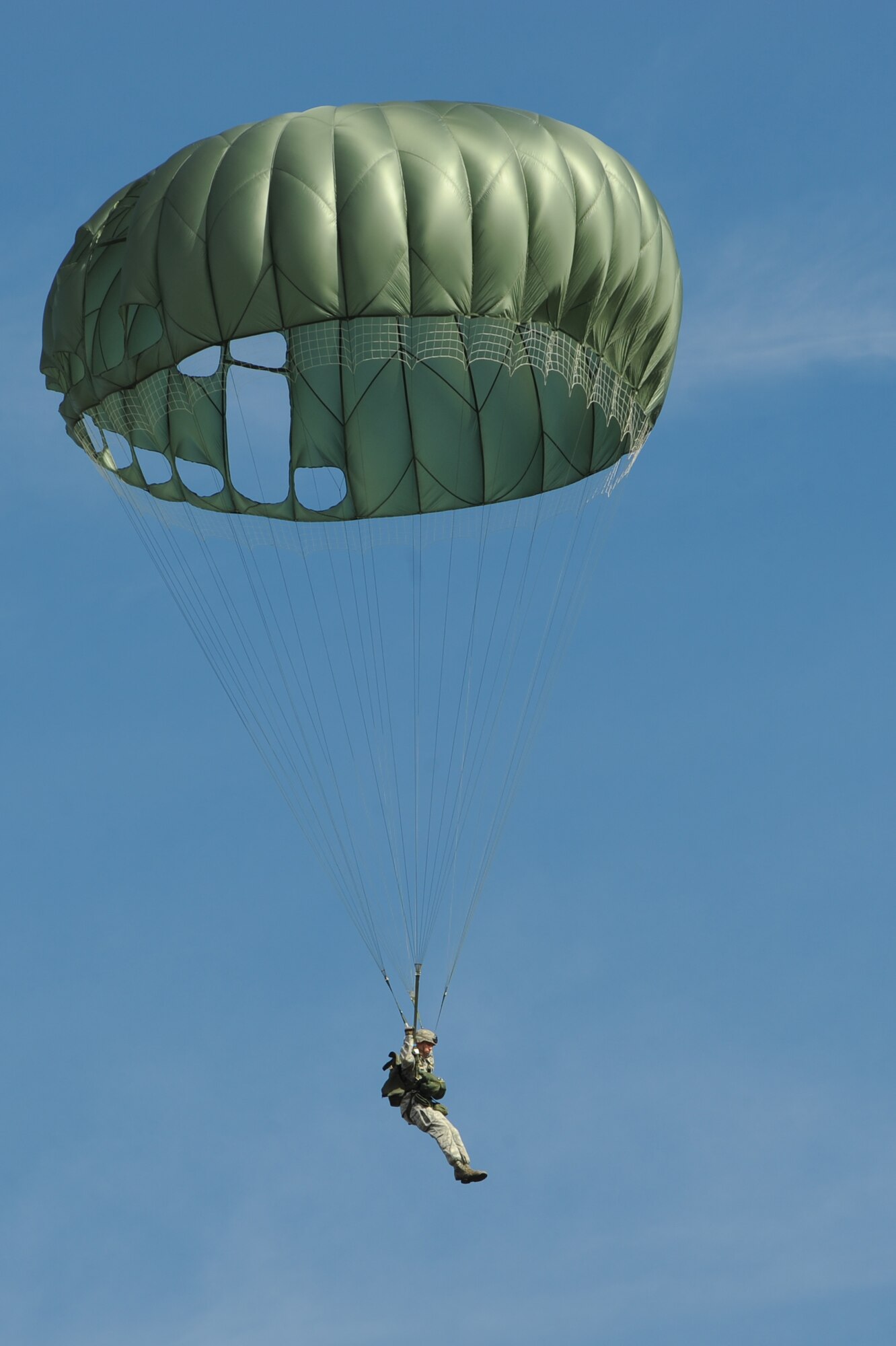 An Airmen from the 820th Base Defense Group, glides to the ground after a static-line jump, Dec. 12, 2015, at Moody Air Force Base, Ga. Members of the 820th BDG deploy worldwide and must maintain qualifications in parachuting by jumping regularly to maintain their readiness. (U.S. Air Force photo by Airman 1st Class Kathleen D. Bryant/Released)
