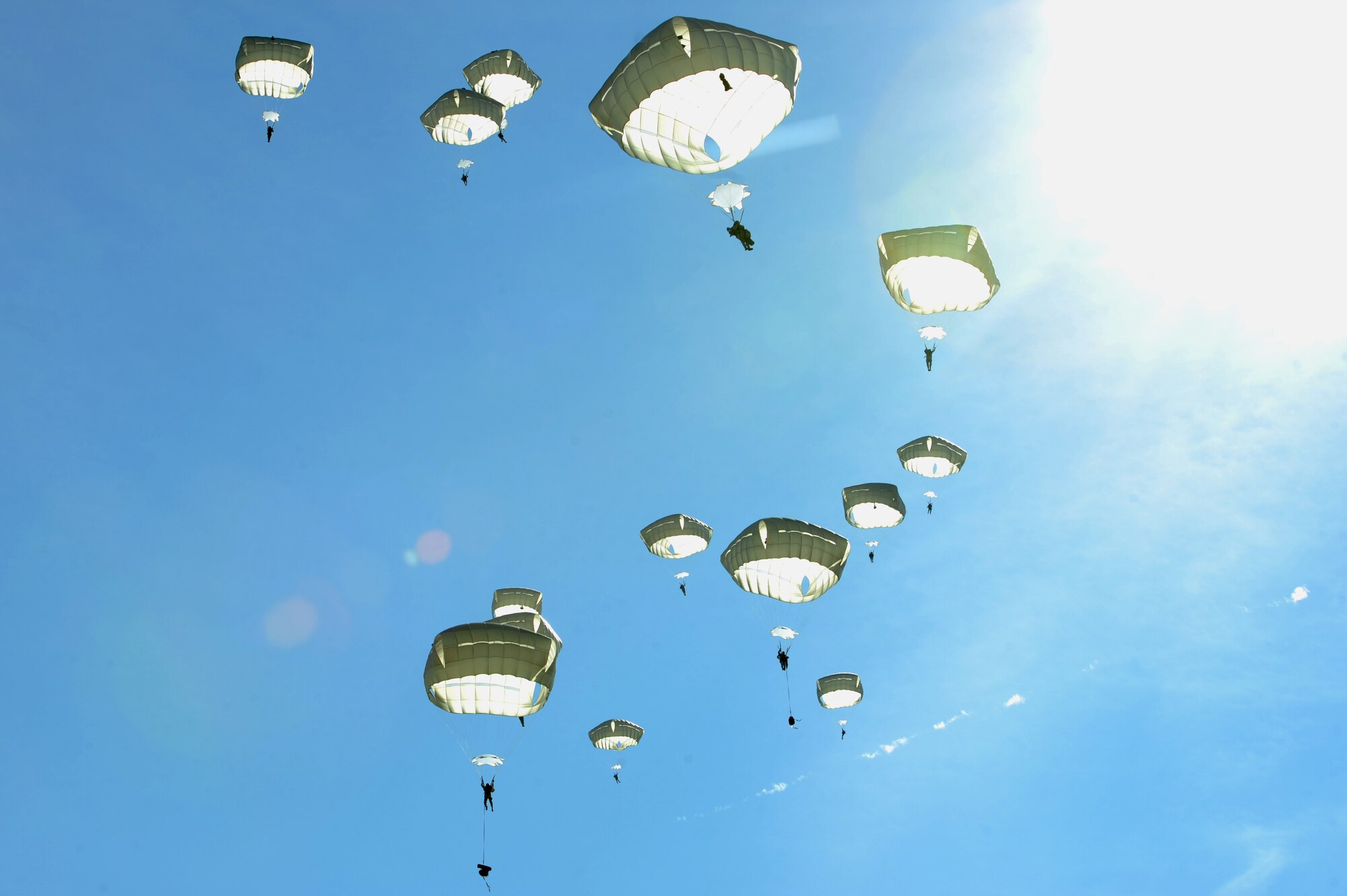 Airmen from the 820th Base Defense Group, glide to the ground after a static-line jump, Dec. 12, 2015, at Moody Air Force Base, Ga. A total of 48 Airmen from the 820th BDG performed the jump for training purposes. (U.S. Air Force photo by Airman 1st Class Kathleen D. Bryant/Released)
