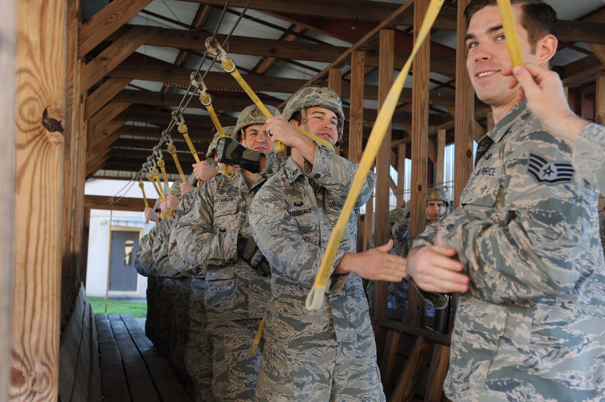 U.S. Air Force Capt. Kenneth Ragsdale, (left), 820th Combat Operations Squadron chief of communication, high-fives Staff Sgt. Steven Trimble, 820th COS parachute program manager,  during static-line jump practice, Dec. 12, 2015, at Moody Air Force Base, Ga. The 820th COS provides planning, training and preparation to the 820th BDG. (U.S. Air Force photo by Airman 1st Class Kathleen D. Bryant/Released)
