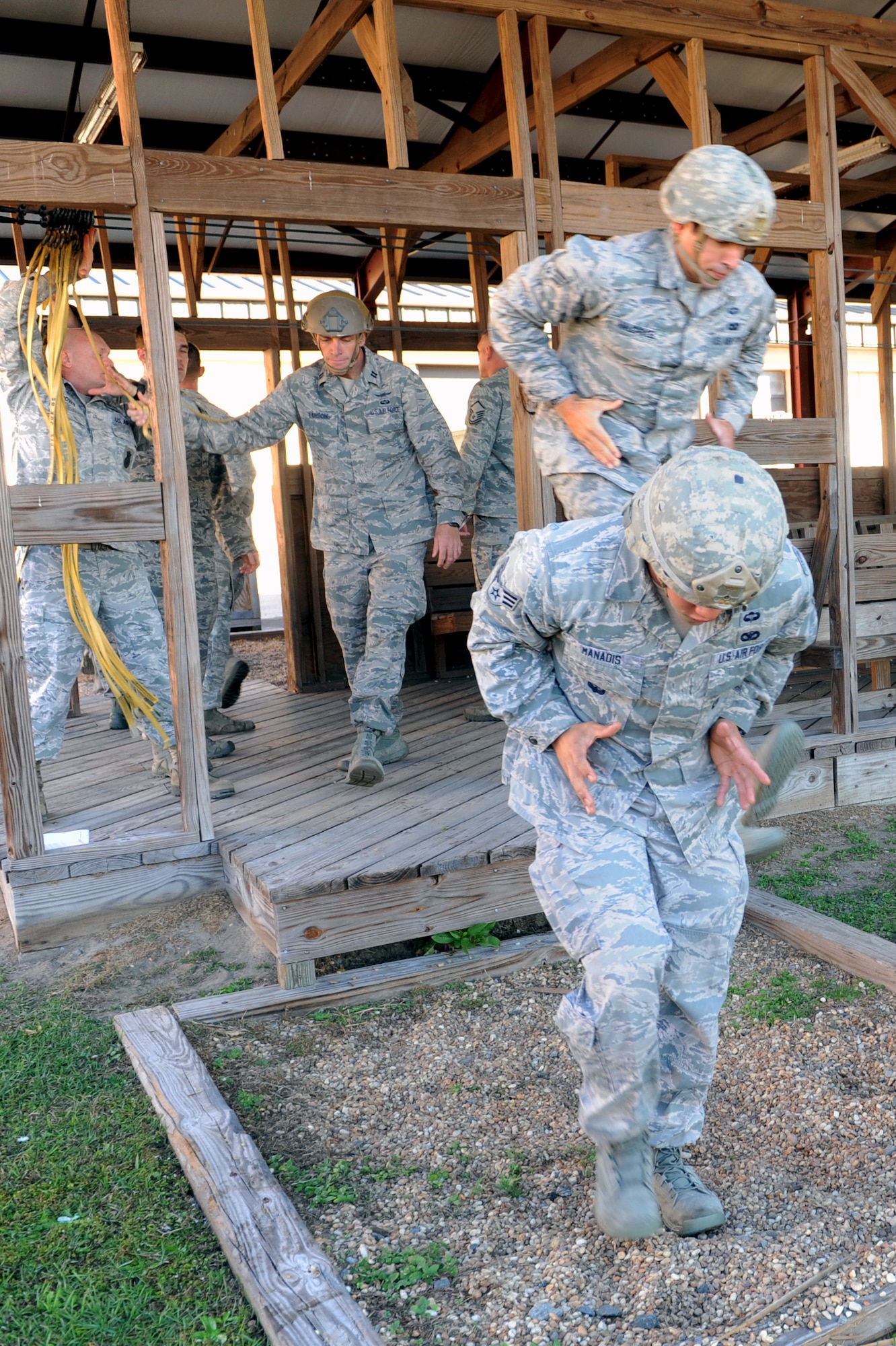 Airmen from the 820th Base Defense Group, practice exiting a simulated aircraft before a static-line jump, Dec. 12, 2015, at Moody Air Force Base, Ga. The Airmen practiced safe exiting and ground-contact techniques multiple times to ensure landing without sustaining injuries. (U.S. Air Force photo by Airman 1st Class Kathleen D. Bryant/Released)
