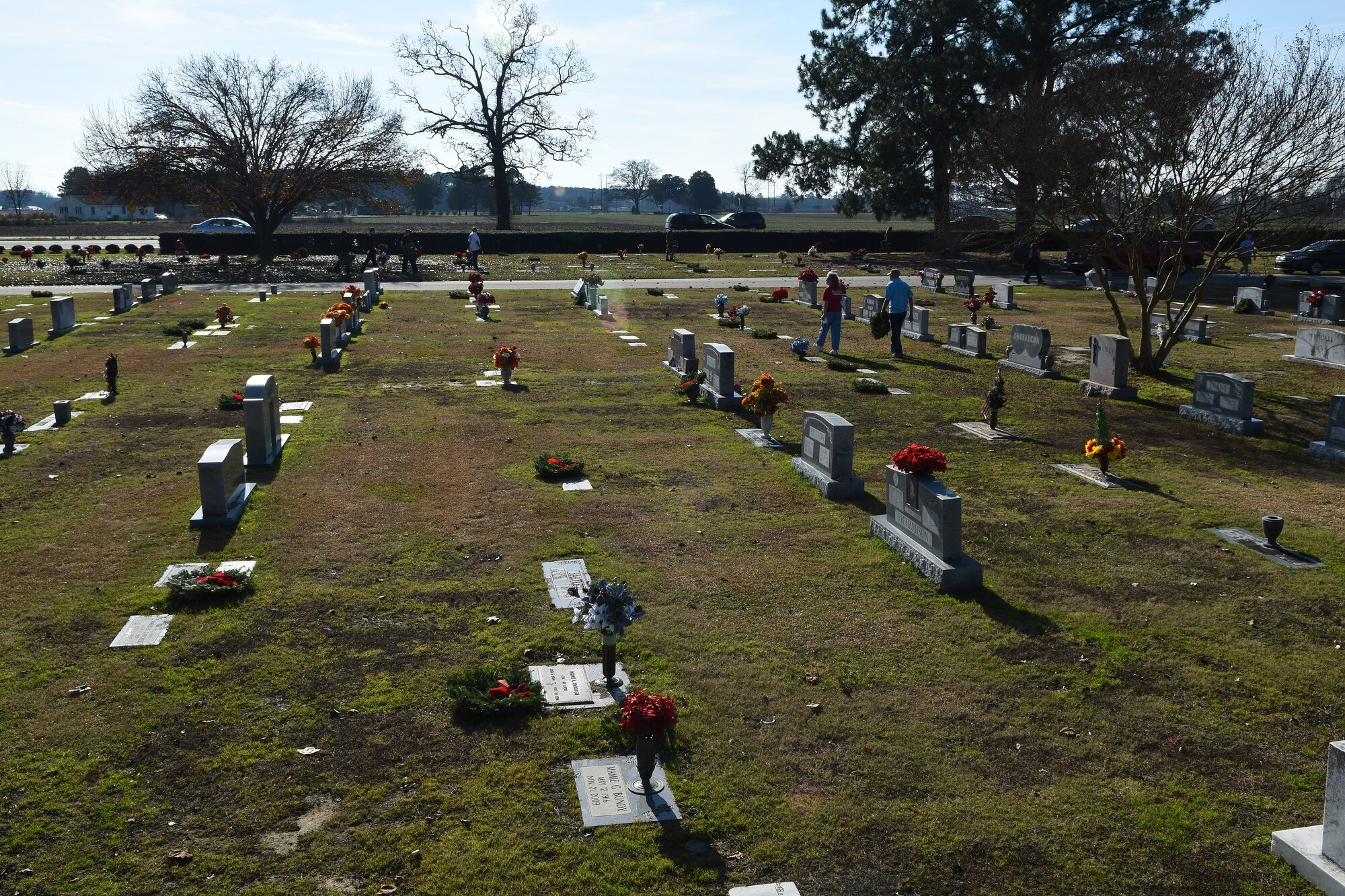 Holiday wreaths rest on the gravestones of former military members during the annual Wreaths Across America event, Dec. 12, 2015, at Evergreen Memorial Cemetery in Princeton, North Carolina. Community and service members who volunteered at the event placed nearly 200 wreaths on the graves of former service members. (U.S. Air Force photo/Senior Airman Aaron J. Jenne)