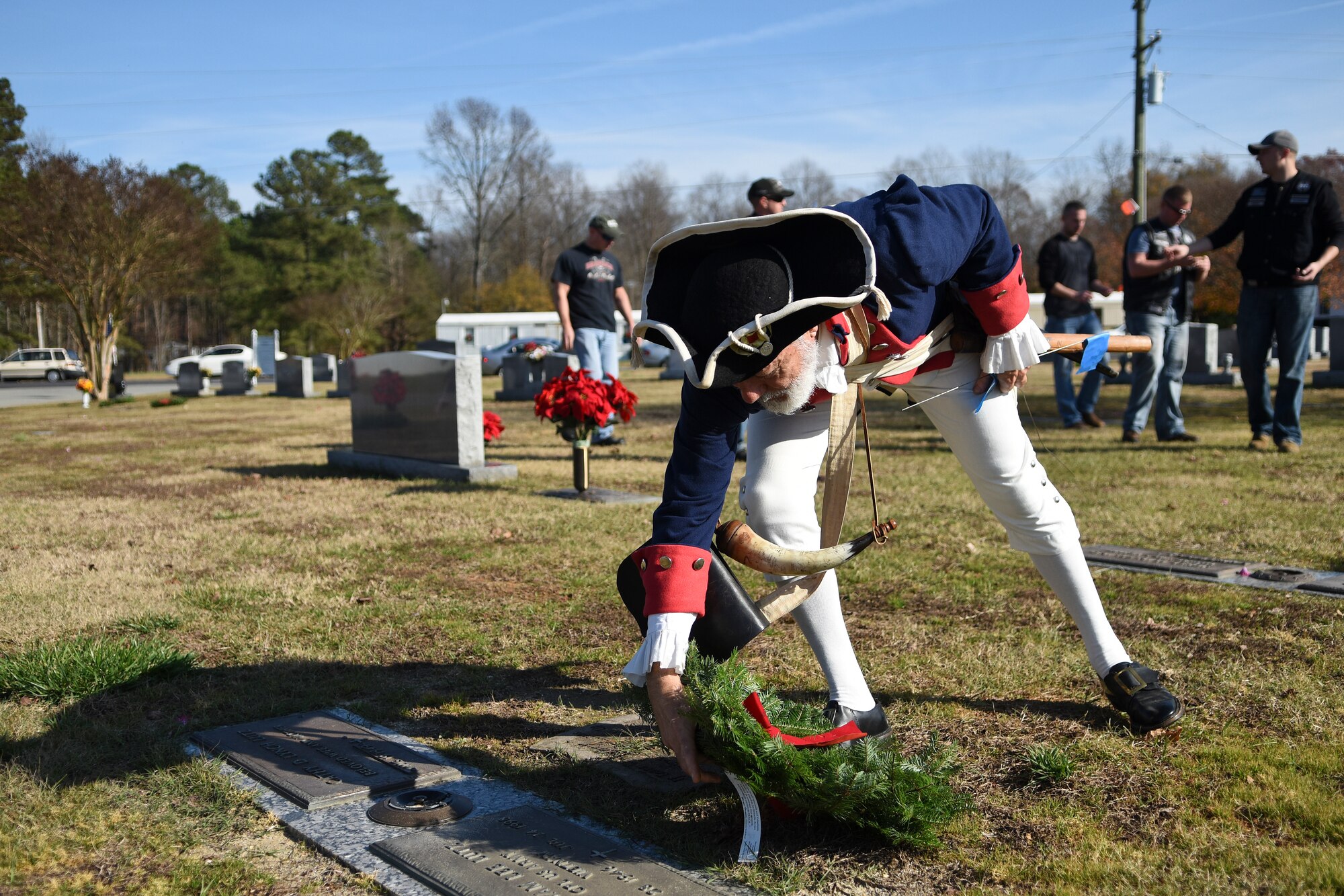 Retired Senior Master Sgt. George Strunk lays a wreath on a grave of a former military member, Dec. 12, 2015, at Evergreen Memorial Cemetery in Princeton, North Carolina. Strunk, a member of the National Society of the Sons of the American Revolution, paid homage to America’s military heritage during the Wreaths Across America event. (U.S. Air Force photo/Senior Airman Aaron J. Jenne)