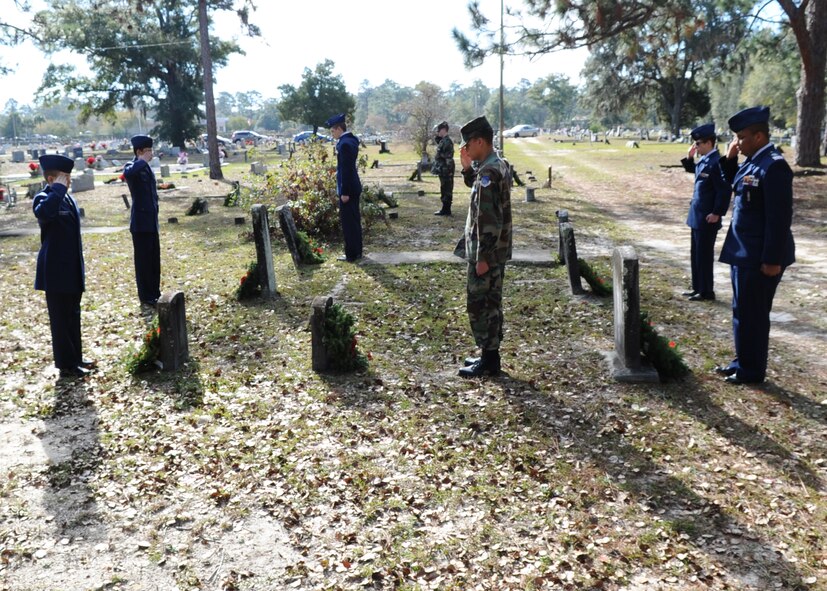 Civil Air Patrolmen render salutes to graves with recently placed wreaths during the Wreaths Across America ceremony at Mount Hope Cemetery, Lynn Haven, Fla. Dec. 12. This event was made possible by thousands of volunteers who organize local ceremonies, raise funds to sponsor wreaths and participate in the events. This ceremony is recognized across all 50 states and U.S. territories. (U.S. Air Force photo by Senior Airman Ty-Rico Lea/Released)