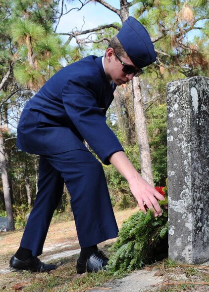 A Civil Air Patrolman lays a wreath across a veteran's grave during the Wreaths Across America ceremony at Mount Hope Cemetery, Lynn Haven, Fla. Dec. 12. This event was made possible by thousands of volunteers who organize local ceremonies, raise funds to sponsor wreaths and participate in the events. This ceremony is recognized across all 50 states and U.S. territories. (U.S. Air Force photo by Senior Airman Ty-Rico Lea/Released)