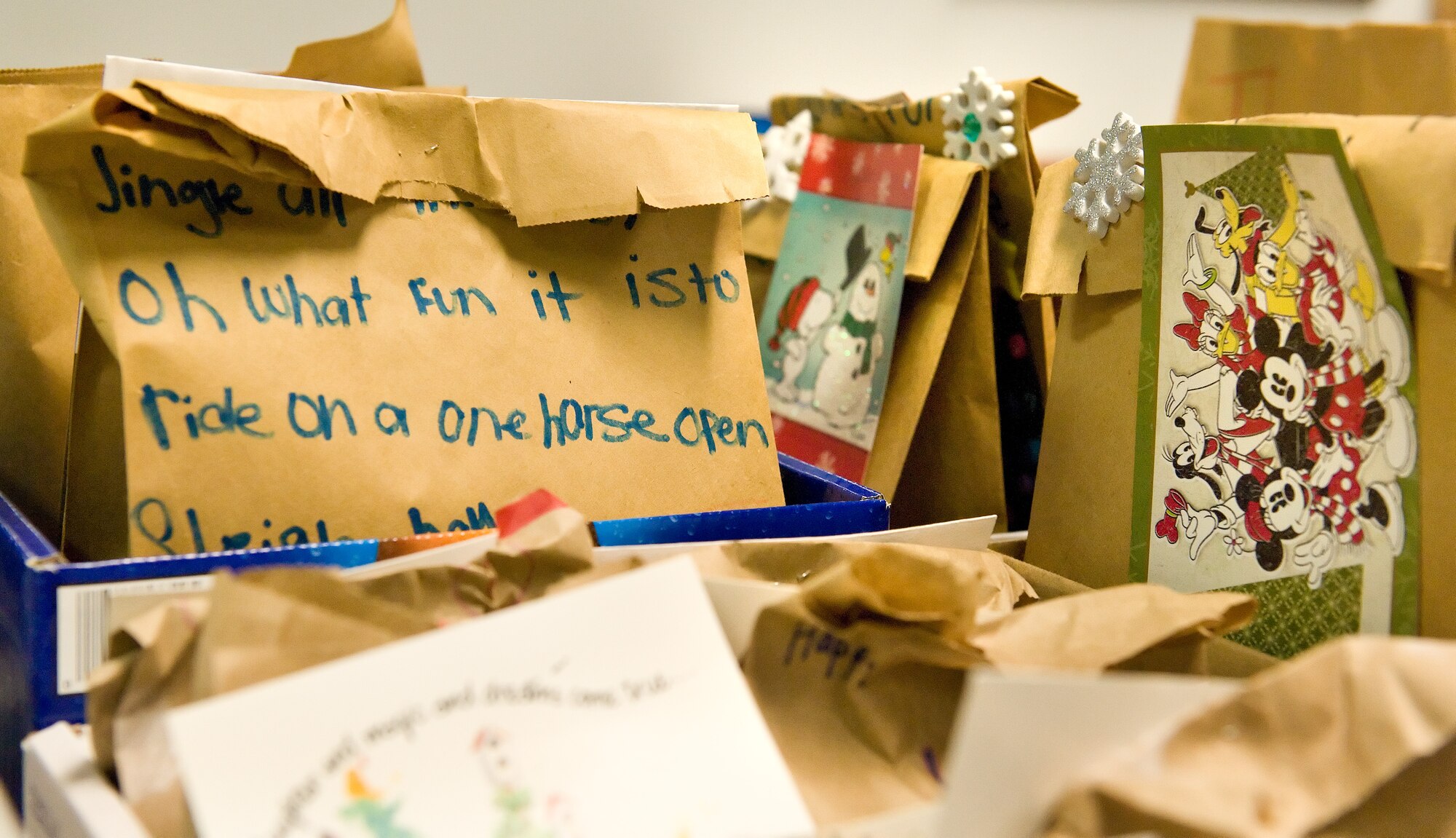 Bags filled with cookies, brownies and fudge for Airmen living in the dormitories sit waiting to be picked up by unit first sergeants Dec. 7, 2015, in the 9th Airlift Squadron auditorium on Dover Air Force Base, Del. Students from local area elementary schools and Dover AFB Youth Center patrons decorated the bags for the annual holiday cookie drop and added their own personal holiday message. In addition to the baked goods, each bag contained a package of hot cocoa mix and oatmeal packets donated by the USO and packaged by key spouses from the Dover Officers' Spouses Club. (U.S. Air Force photo/Roland Balik)