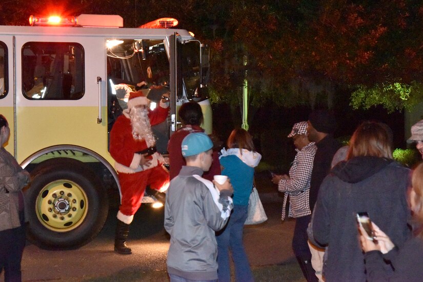 Santa arrived by fire truck to surprise the children during the annual Christmas tree lighting ceremony at  JB Charleston - WS on Dec. 3, 2015 in Charleston, S.C. Hot chocolate was served and carolers entertained the audience with holiday songs. (photo by Jessica Donnelly/JB Charleston FSS)