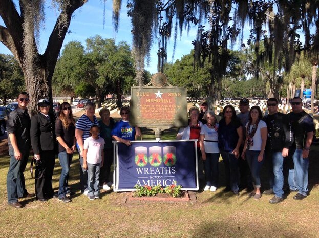 (left to right) HM2 Alexander Vernon, FC3 Kaitlin Billingsley, Karin Vernon, Bea Billingsley, in front of Bea Billingsley, Juliana Alcantara, Gena Waltraud, Hazel Cole, Linda Hedden, Brian Hedden, Liz Capahungan, Brenda Sparks, Capt. Timothy Sparks, JB Charleston deputy commander, Nancy Tarwater, Cdr. David Tarwater, JB Charleston, NSA executive officer, Lcdr. Russell Hale pose for a photograph after placing wreaths at the Beaufort National Cemetery in Beaufort, S.C. on December 12, 2015 as part of the Wreaths Across America world-wide event.