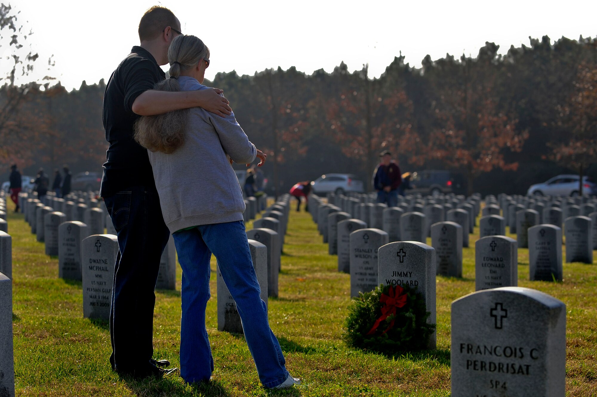 A family pays respect to their family member during the annual wreath laying ceremony at the Albert G. Horton, Jr., Memorial Veterans Cemetery in Suffolk, Va., Dec. 12, 2015. The cemetery is one of three state veterans’ cemeteries operated by the Virginia Department of Veterans Services. (U.S. Air Force photo by Senior Airman Breonna Veal)