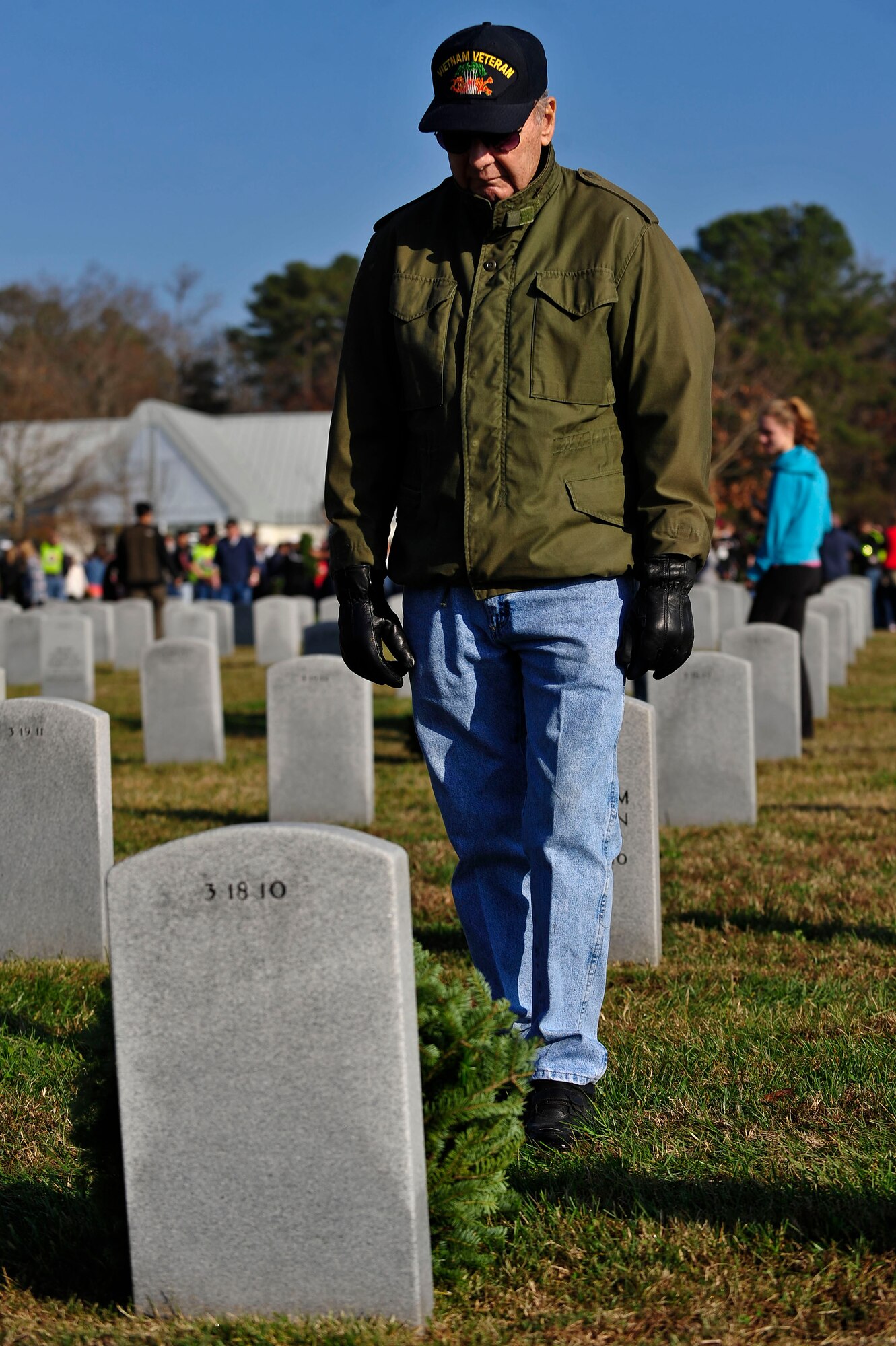 Stephen Bell, retired U.S. Soldier, pays respect to his wife after laying a wreath at her gravesite during the annual wreath laying ceremony at the Albert G. Horton, Jr., Memorial Veterans Cemetery in Suffolk, Va., Dec. 12, 2015. More than 3,000 people came out to lay a wreath for a family member, friend or veteran during the annual event. (U.S. Air Force photo by Senior Airman Breonna Veal)
