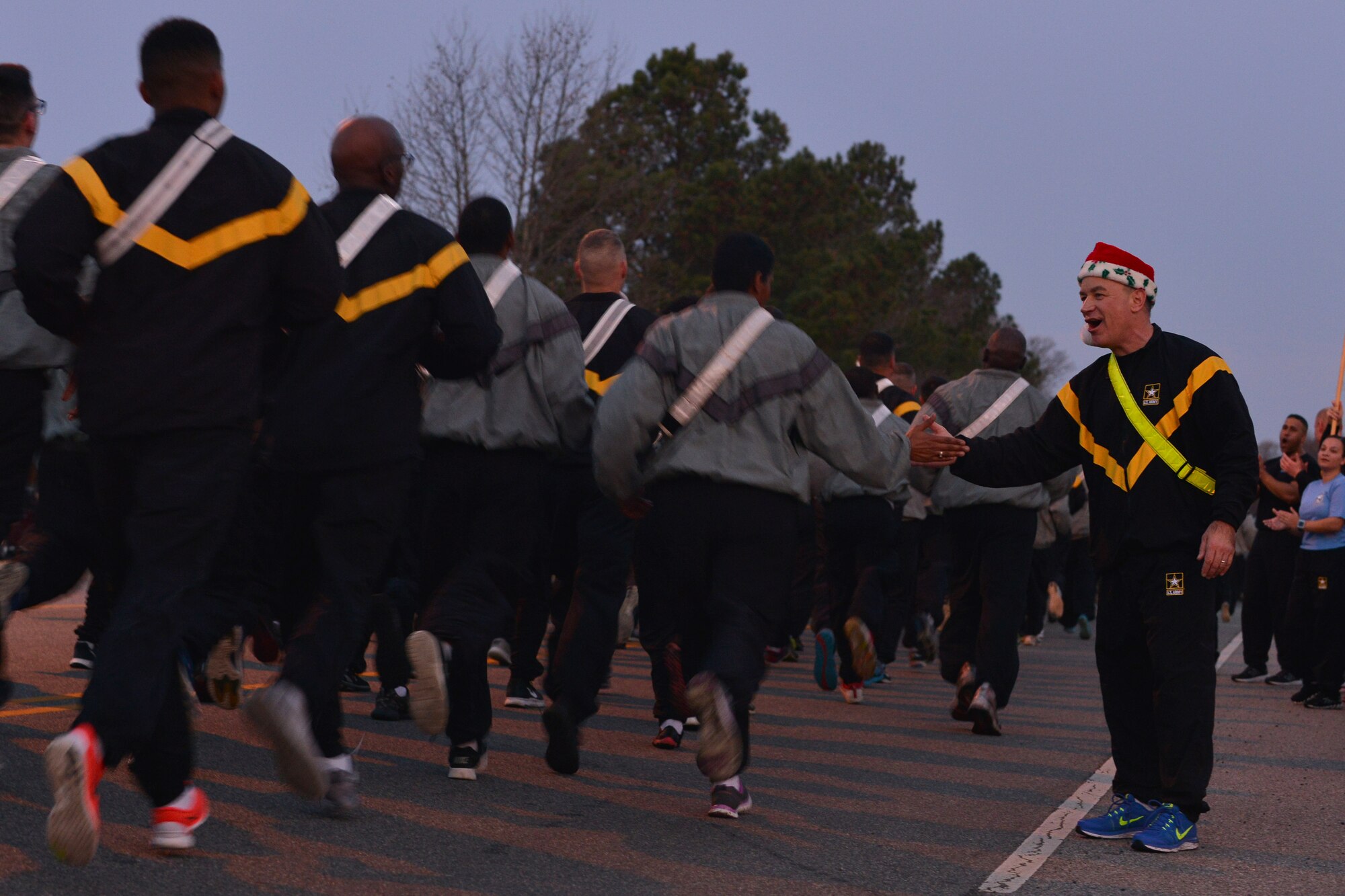 U.S. Army Col. William Galbraith, the commander of the 733rd Mission Support Group, high fives U.S. Service members participating in the Joint Base Langley-Eustis annual holiday run at Fort Eustis, Va., Dec. 11, 2015. Installation leadership supported the runners throughout the event by cheering them on and shouting words of encouragement. (U.S. Air Force photo by Staff Sgt. Natasha Stannard)