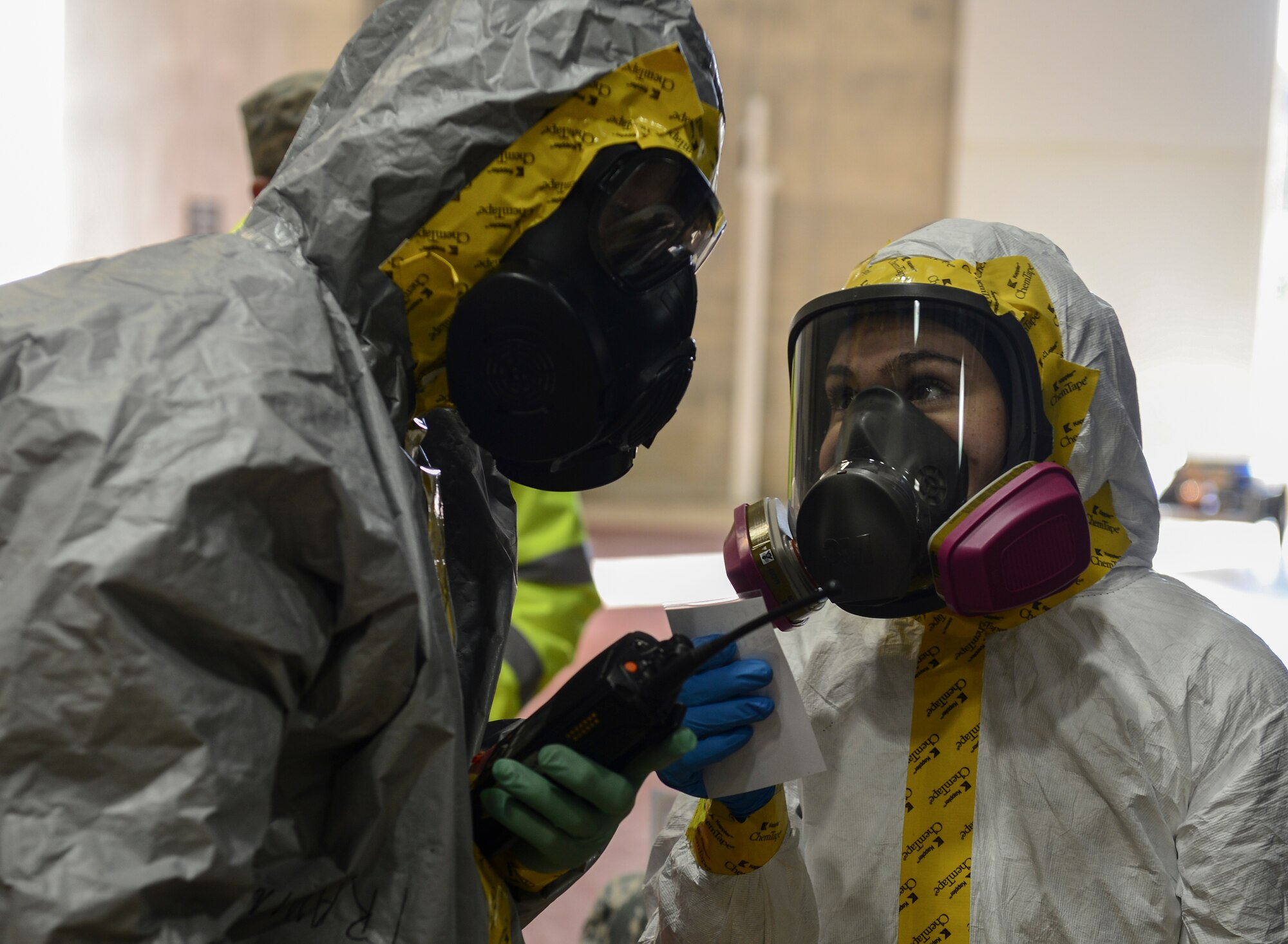 Airmen from Royal Air Forces Lakenheath and Mildenhall’s bioenvironmental flights determine how to control hazardous material during a joint training exercise at RAF Lakenheath, England, Dec. 9, 2015. The training was held to ensure all response elements are fully trained and capable of working together in the event of a hazardous occurrence. (U.S. Air Force photo by Senior Airman Dawn M. Weber/Released)