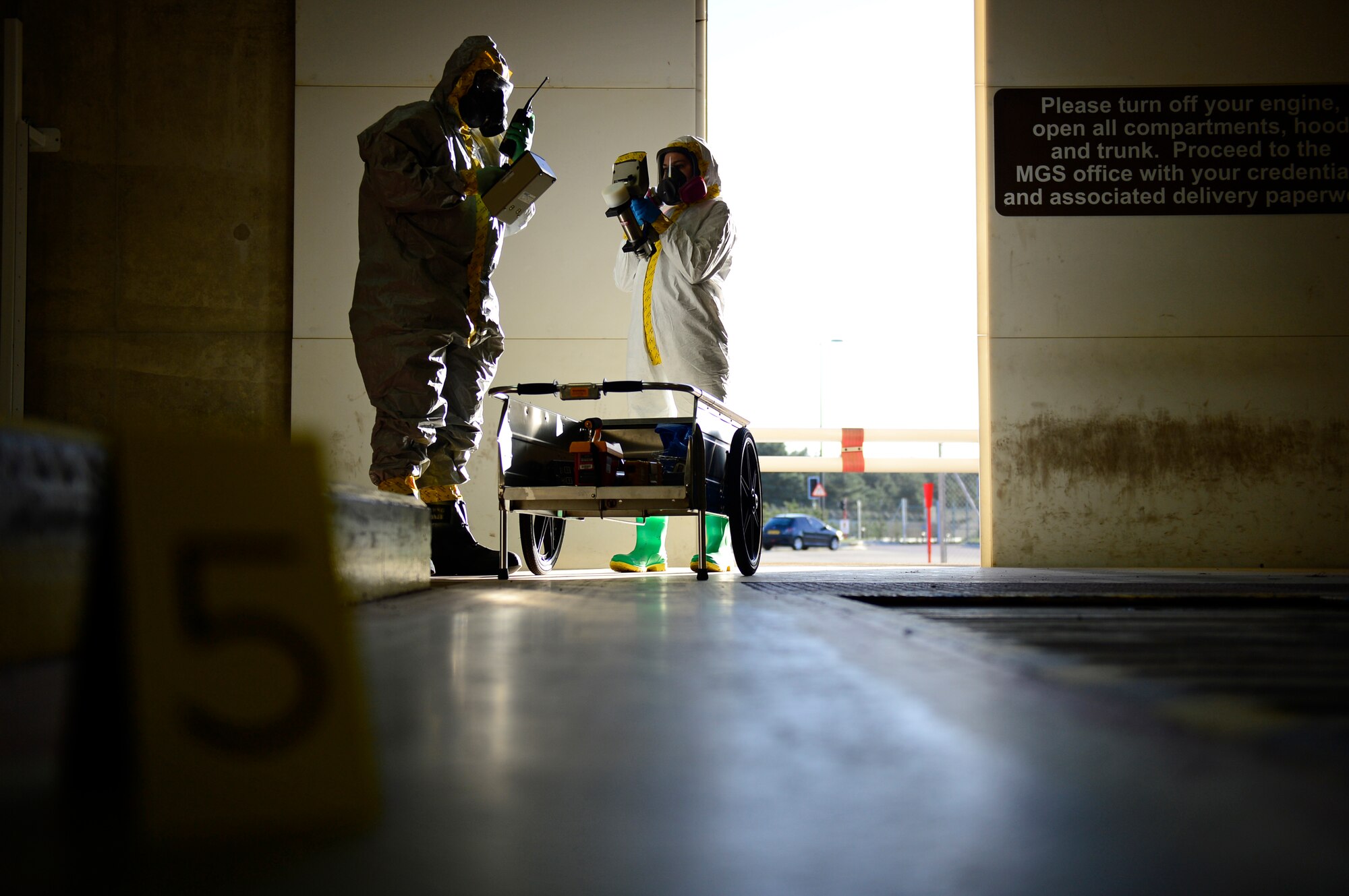 Airmen from Royal Air Forces Lakenheath and Mildenhall’s bioenvironmental flights prepare to assess a contaminated area during a joint training exercise at RAF Lakenheath, England, Dec. 9, 2015. The training was planned to ensure all response elements are fully trained and capable or working together in the event of a hazardous occurrence.  (U.S. Air Force photo by Airman 1st Class Erin Babis/Released)