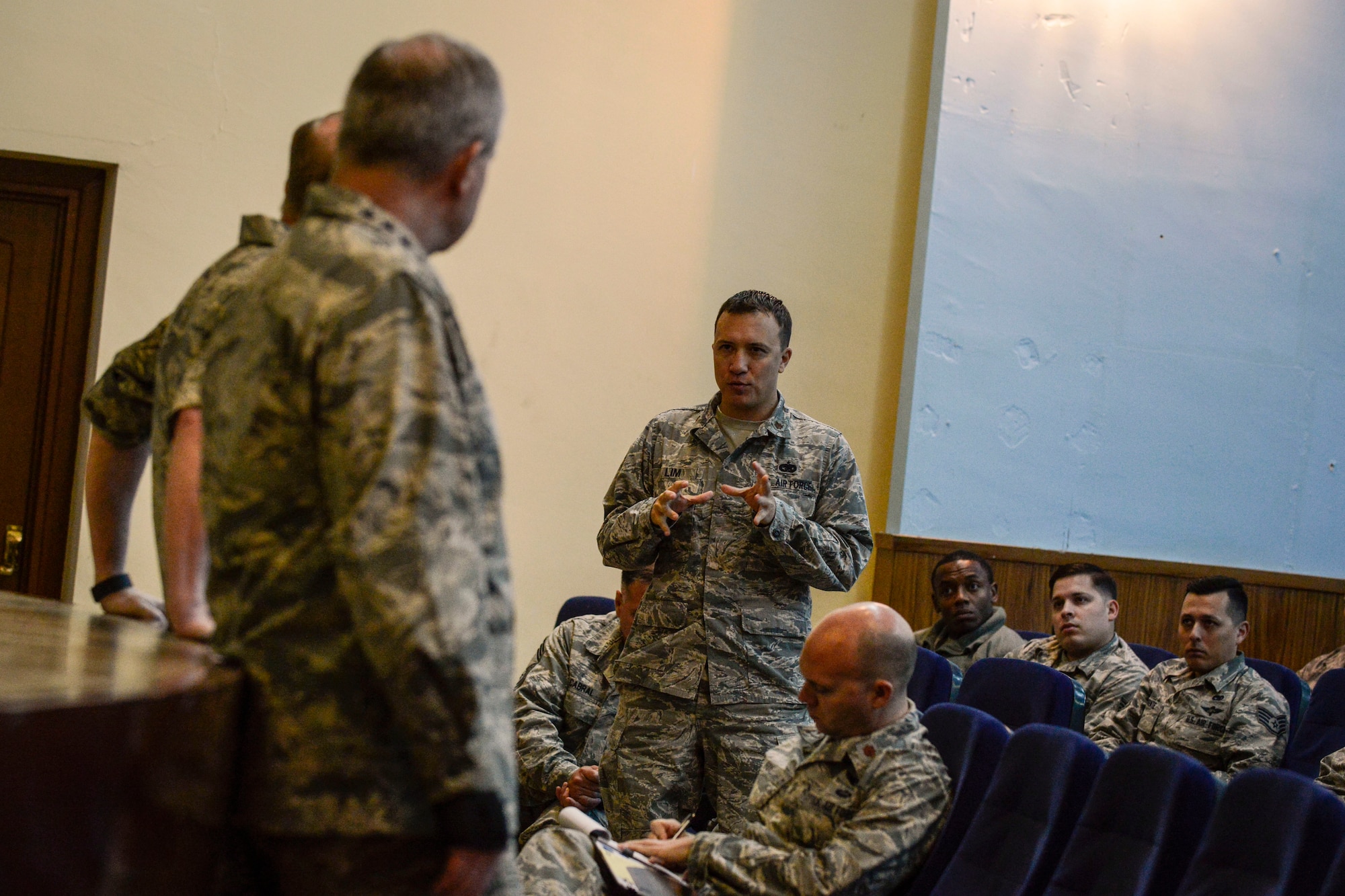 Maj. B.J. Lim, 496th Air Base Squadron director of operations, asks a question during an all-call at Morón Air Base, Spain, Dec. 8, 2015. Air Force Chief of Staff Gen. Mark A. Welsh III and Chief Master Sgt. of the Air Force James A. Cody visited Morón to engage with Airmen and speak to them about their contributions to the joint mission, recent performance reporting changes and acknowledge outstanding performers of the 496th Air Base Squadron. (courtesy photo)