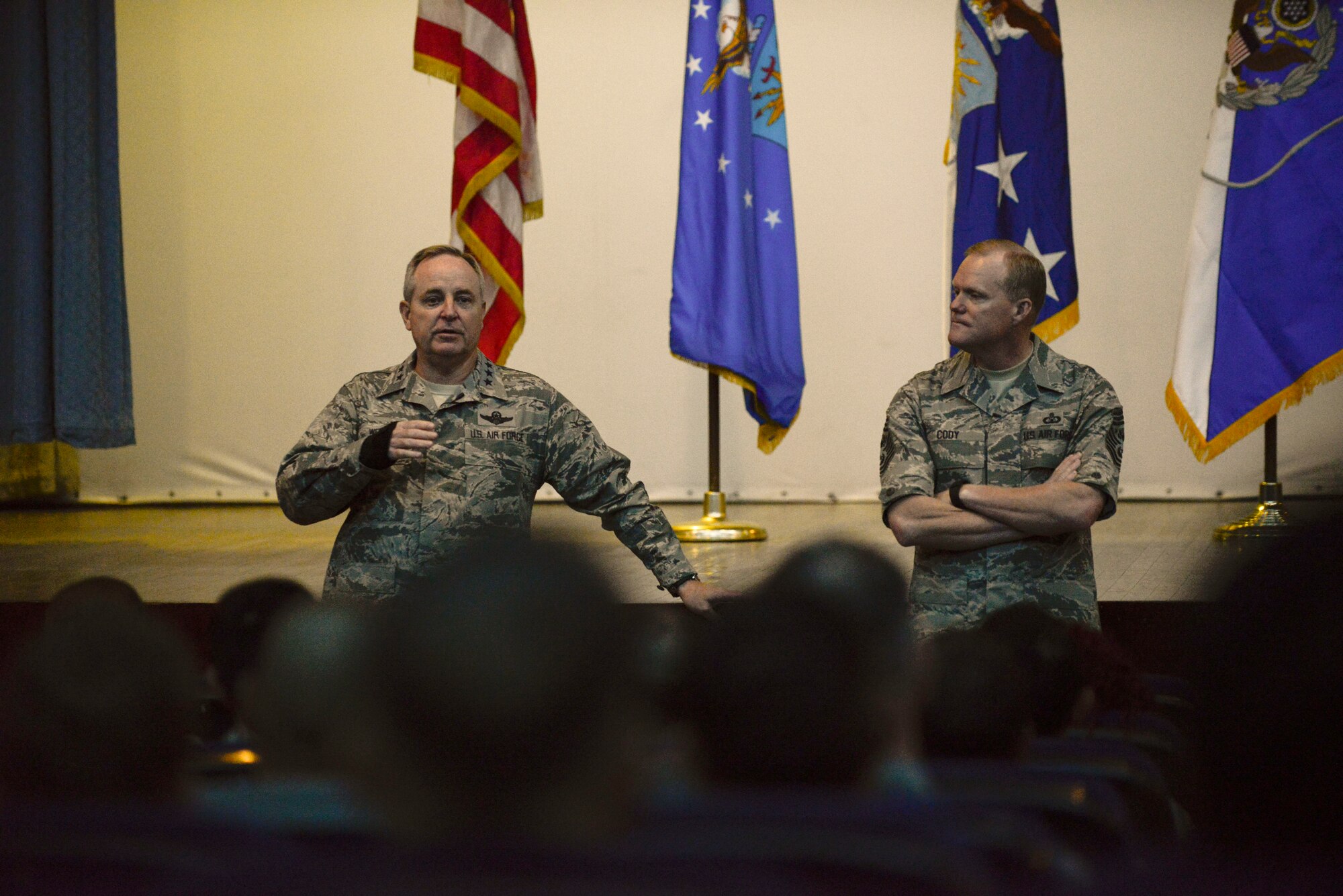 Air Force Chief of Staff Gen. Mark A. Welsh III and Chief Master Sgt. of the Air Force James A. Cody speak during an all-call at Morón Air Base, Spain, Dec. 8, 2015. Welsh and Cody visited Morón to engage with Airmen by thanking them for their dedication and discussing changes to performance reporting systems. (courtesy photo)