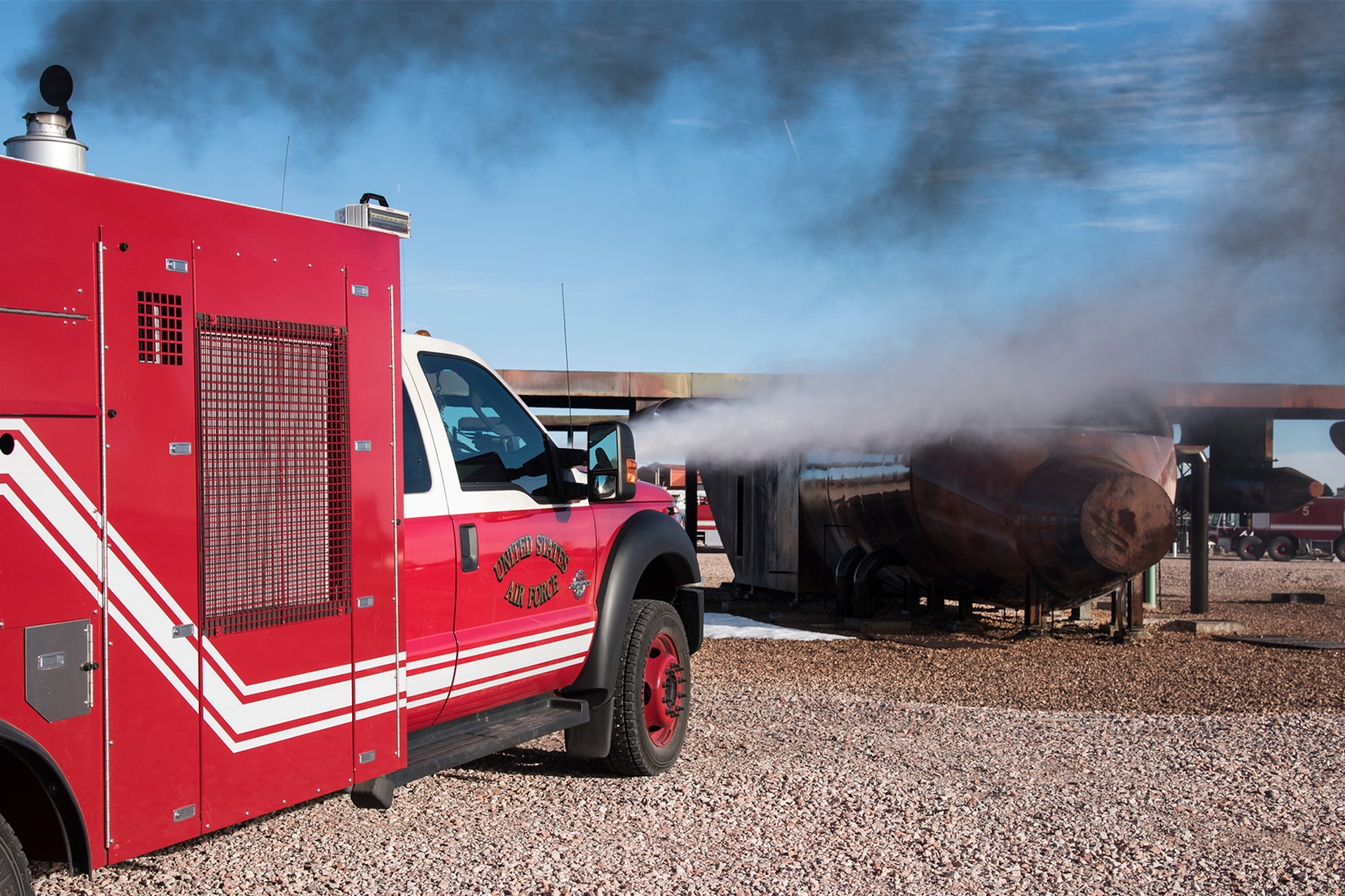 PETERSON AIR FORCE BASE, Colo. – Members of the Peterson Fire Department simulate an aircraft fire for training with the new Rapid Intervention Vehicle, Dec. 8, 2015. The RIV is one of two new firefighting vehicles the FD has received in the last six months with new ultra high pressure technology to more efficiently use water. (U.S. Air Force photo by Senior Airman Tiffany DeNault)