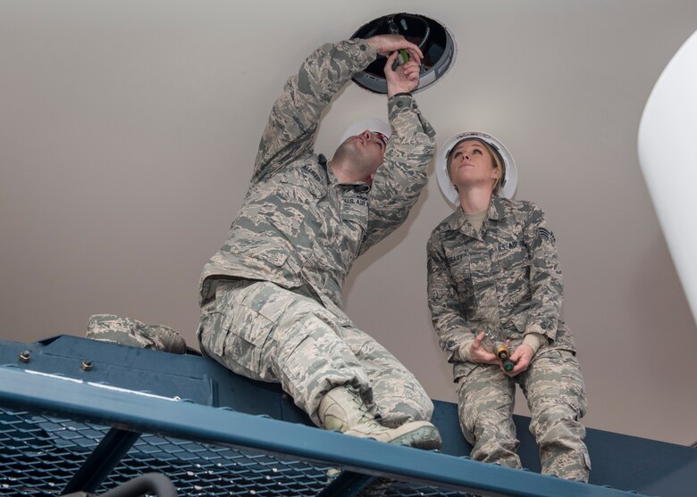 PETERSON AIR FORCE BASE, Colo. –Staff Sgt. Jason Allred and Senior Airman Genevieve McGeary, 21st Civil Engineer Squadron electricians, troubleshoot the lights on the canopy at the gas station Dec. 9, 2015. They used proper safety techniques to avoid electrical shock and then sought out the source of the inoperative light. (U.S. Air Force photo by Senior Airman Rose Gudex)