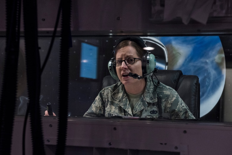 PETERSON AIR FORCE BASE, Colo. – Master Sgt. Shannon Brady, 21st Aerospace Medicine Squadron flight chief, teaches students in a helicopter refresher course in the high altitude chamber Dec. 10, 2015. The high altitude chamber provides initial and refresher training for pilots and aircrew so they are able to recognize the effects low oxygen has on their bodies at a simulated altitude of 25,000 feet. The chamber at Peterson AFB is one of 11 in the Air Force. (U.S. Air Force photo by Senior Airman Rose Gudex)
