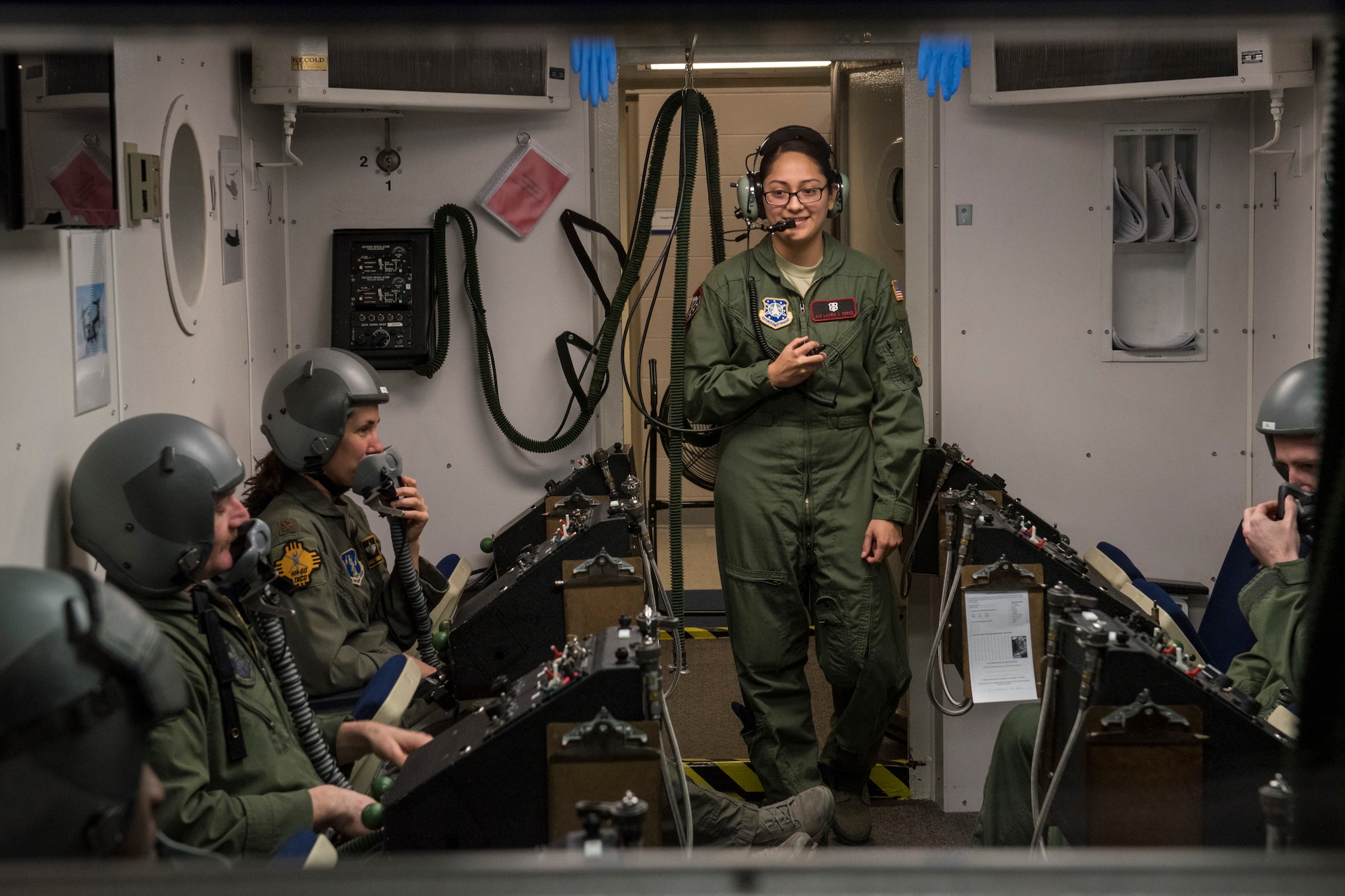 PETERSON AIR FORCE BASE, Colo. – Airman 1st Class Laura Perez, 21st Aerospace Medical Squadron aerospace and operational physiological technician, briefs pilots and aircrew members from across the nation about the high altitude chamber simulation they’re about to participate in Dec. 10, 2015. The students were there for a refresher helicopter course, which highlighted spatial disorientation, risk reduction and situational awareness. The chamber allowed them to feel the effects of low oxygen at a high altitude in a safe training environment, which would help them recognize those symptoms in a real situation. (U.S. Air Force photo by Senior Airman Rose Gudex)