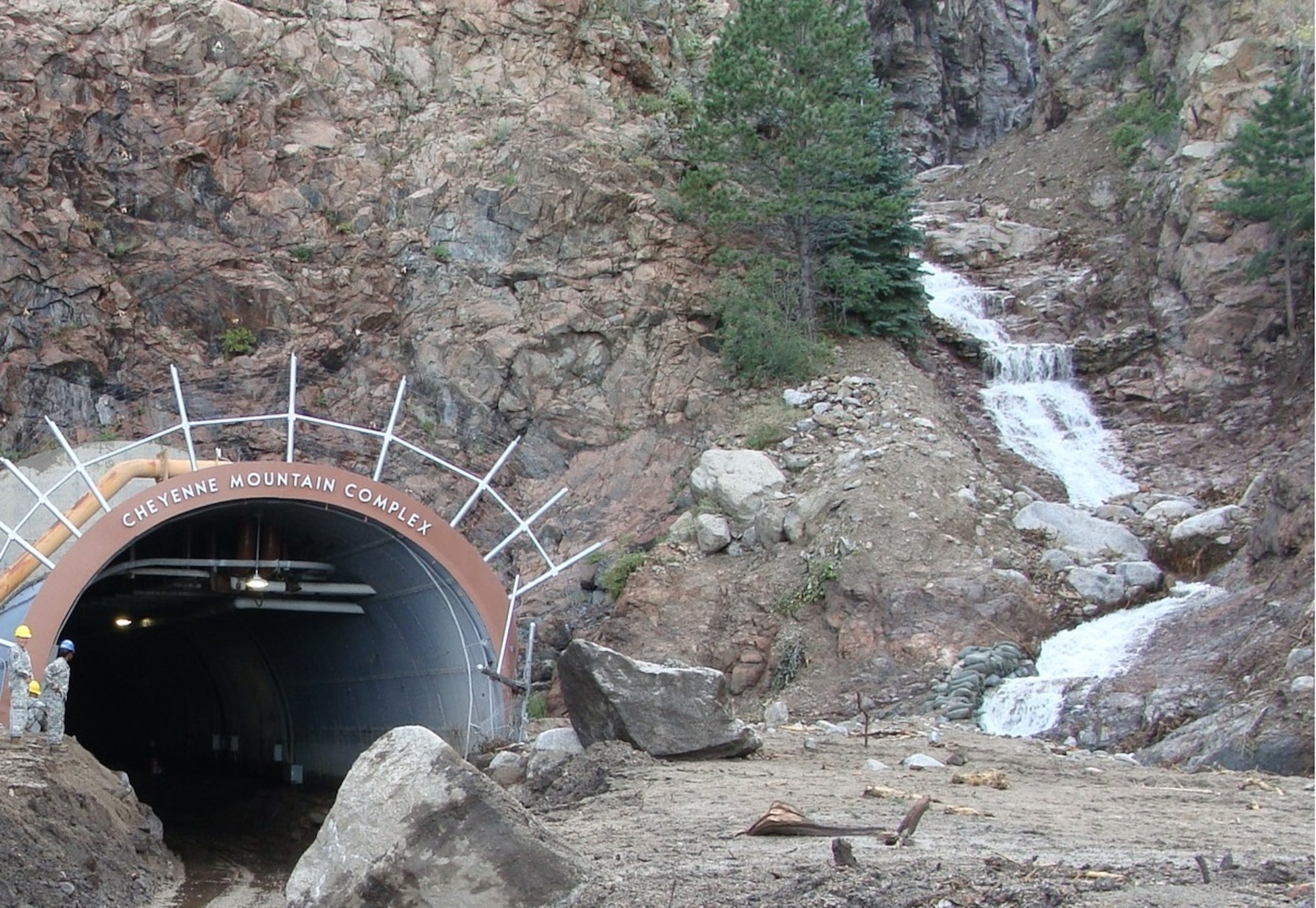 CHEYENNE MOUNTAIN AIR FORCE STATION, Colo. - In September 2013 more than 7,200 cubic yards, about 1,500 standard dump truck loads, of debris heaped up in front of the north portal entrance into Cheyenne Mountain Air Force Station following a 500-1,000 year rain event. The portal is set to reopen to vehicle traffic Dec. 23.  (Courtesy photos)
