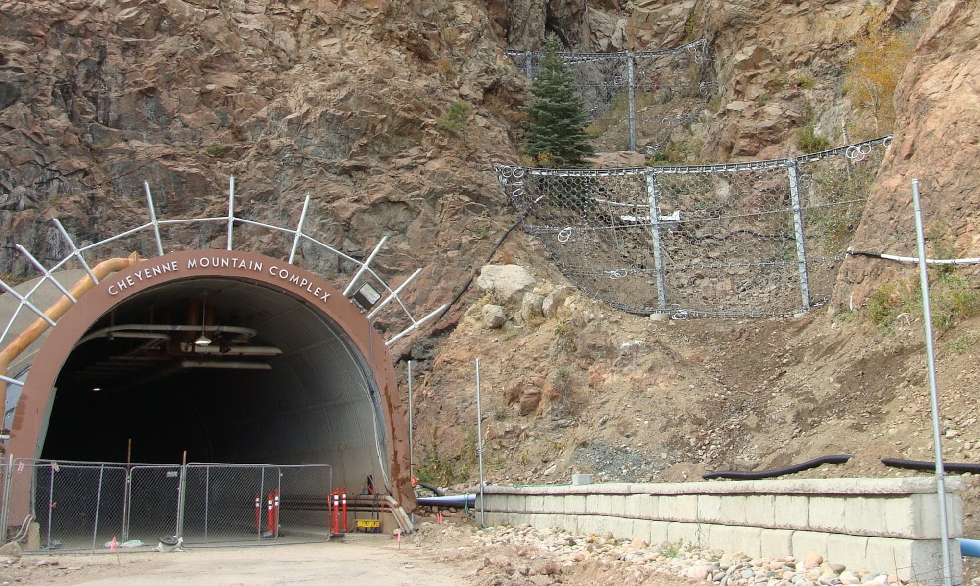 CHEYENNE MOUNTAIN AIR FORCE STATION, Colo. - A view of the north portal entry taken in October 2015 after projects to restore the entrance following damage from 2013 mudslides. Construction is nearing completion. The ring nets were placed into the canyon to catch large debris to prevent a similar event from happening again. The portal is slated to open for vehicle traffic Dec. 23. (Courtesy photos)