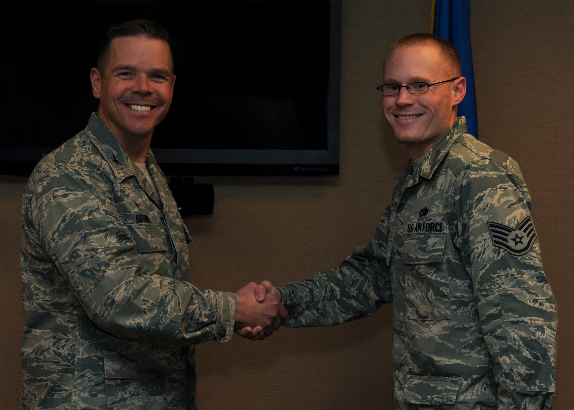 (From right) U.S. Air Force Staff Sgt. Roland Ryan, a 373rd Training Squadron aerospace propulsion technical training instructor, is congratulated by U.S. Air Force Col. Charles Brown Jr., 19th Airlift Wing commander, as Combat Airlifter of the Week Dec. 14, 2015, at Little Rock Air Force Base, Ark. Ryan has played an integral role as the lead management internal control toolset inspector for numerous in-house inspections. (U.S. Air Force photo by Airman 1st Class Mercedes Muro) 


