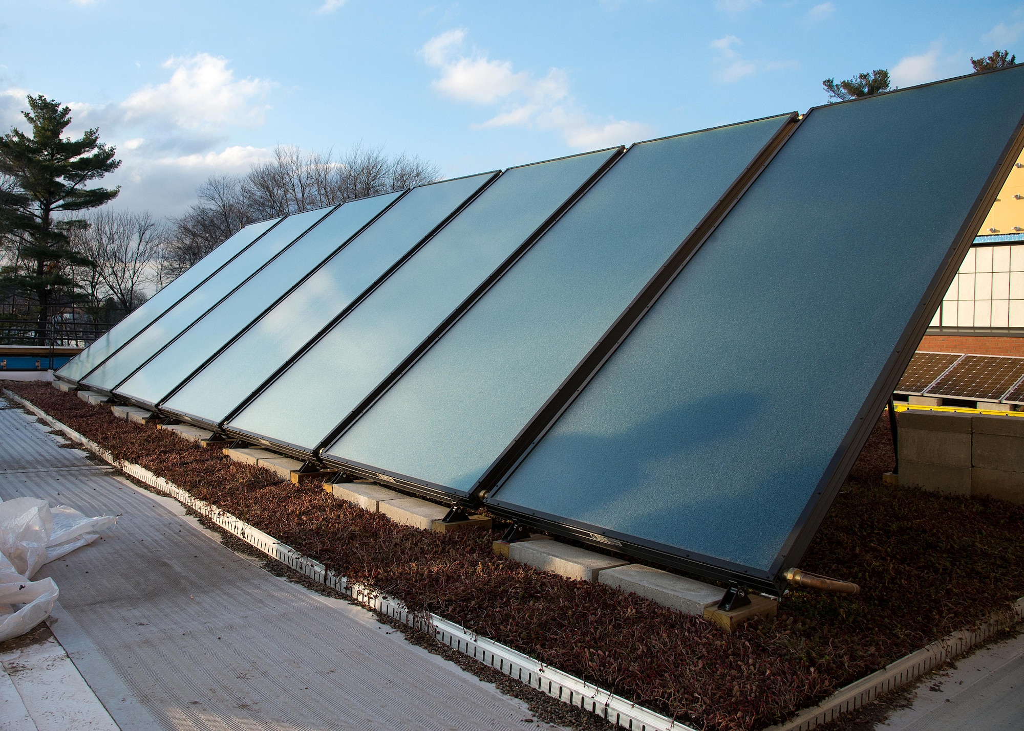 Solar panels on the roof of the new Hanscom Middle School will serve as a learning area for faculty once the school opens. The school will also include indoor and outdoor learning areas, Science Technology Engineering Math-enabled classrooms and an integrated building system, which include a rainwater harvesting system for teaching. (U.S. Air Force photo by Mark Herlihy)