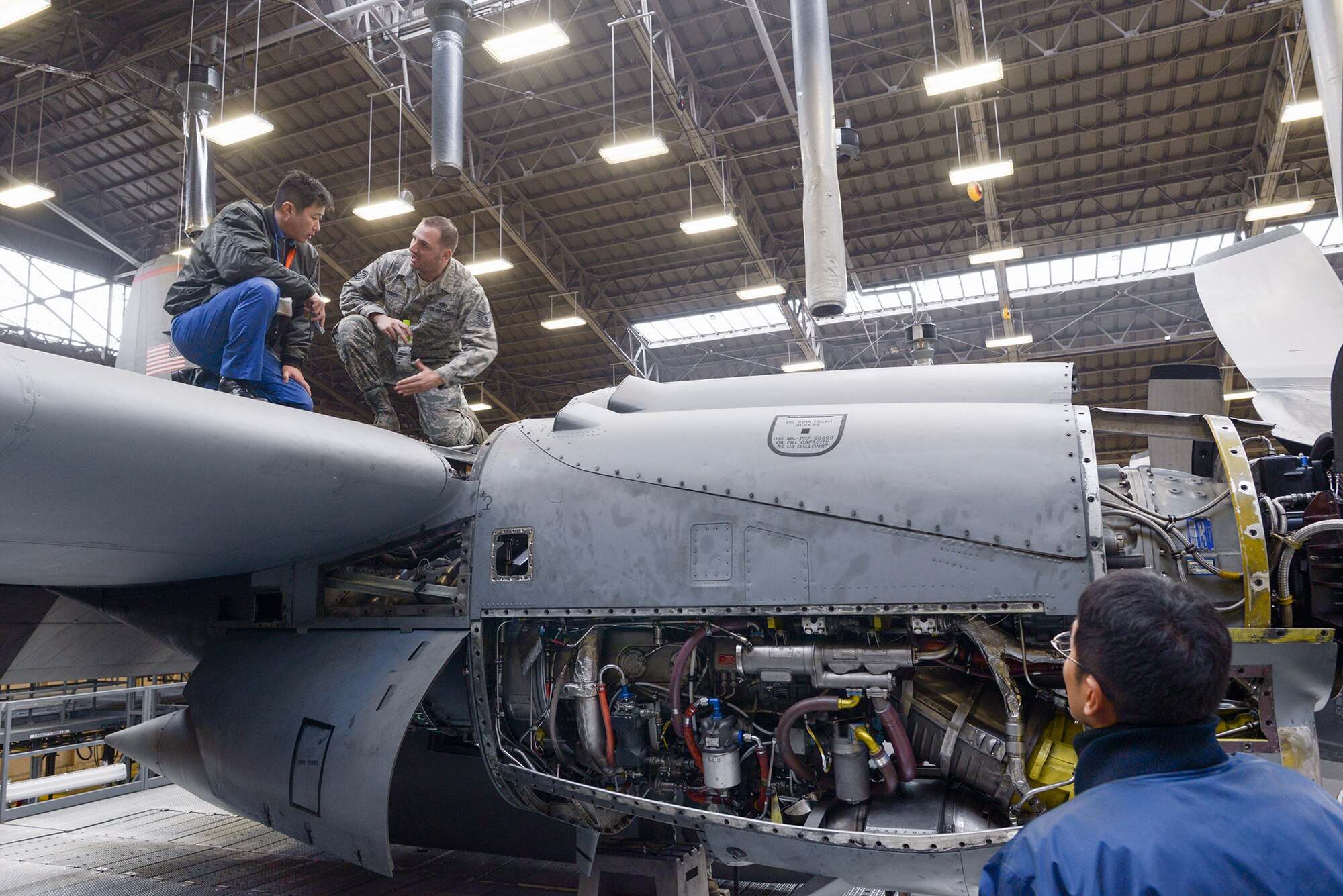 Tech. Sgt. Jeff De Remer, 374th Maintenance Squadron repair and reclamation section
chief, explains specifics regarding Yokota's C-130 Hercules maintenance to members of
the Japan Maritime Self-Defense Force at Yokota Air Base, Japan, Dec. 11, 2015.
Members with the 374th Maintenance Group discussed maintenance with the JSMDF members and gave them tours of multiple facilities at Yokota. (U.S. Air Force
photo by Staff Sgt. Cody H. Ramirez/Released)