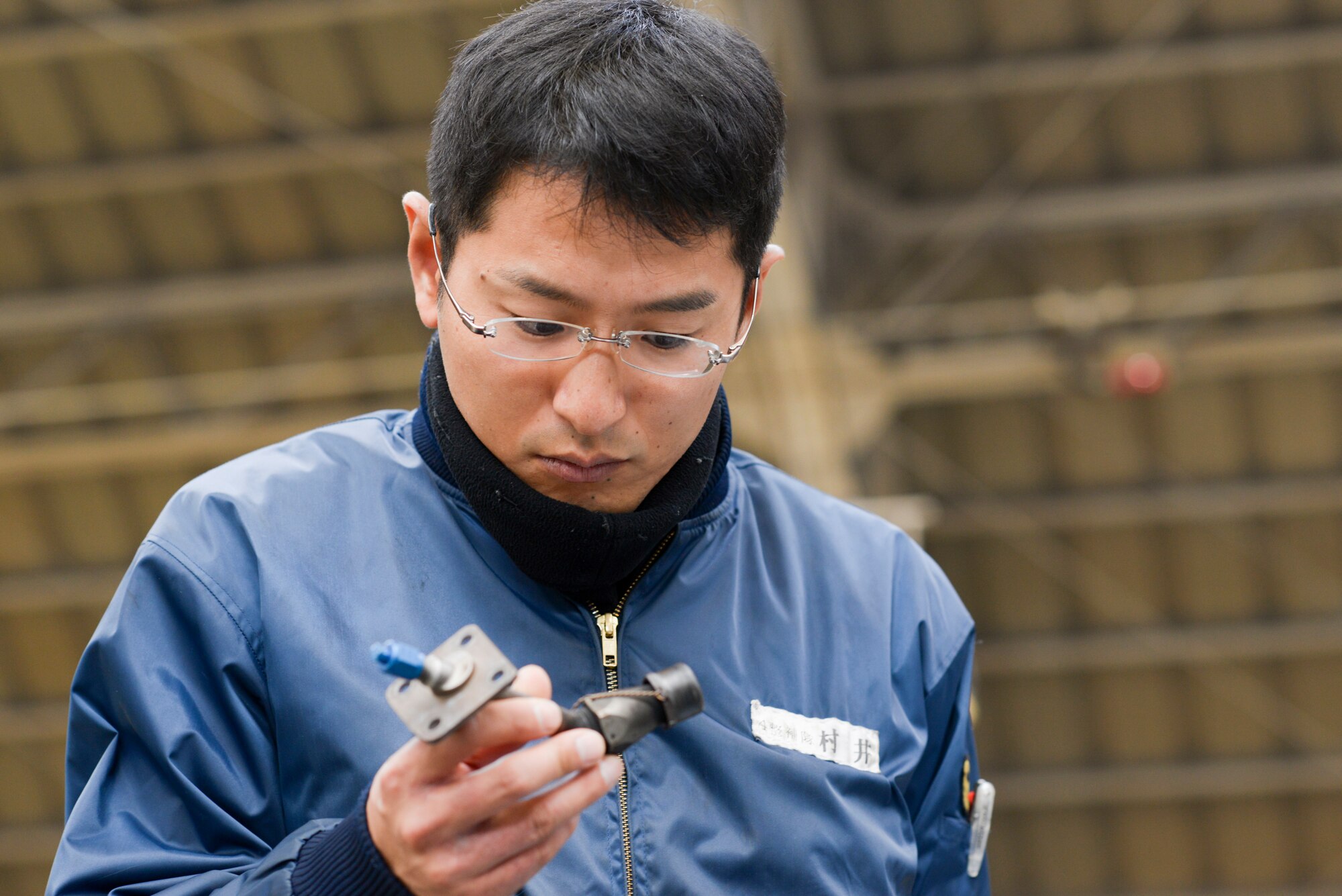 Japan Maritime Self-Defense Force Petty Officer 2nd Class Takeshi Murai, 4
Maintenance Squadron, inspects the part of a C-130 Hercules engine during a facility
tour at Yokota Air Base, Japan, Dec. 11, 2015. Nine JMSDF members visited Yokota to
learn about C-130 Hercules maintenance conducted at Yokota. (U.S. Air Force
photo by Staff Sgt. Cody H. Ramirez/Released)