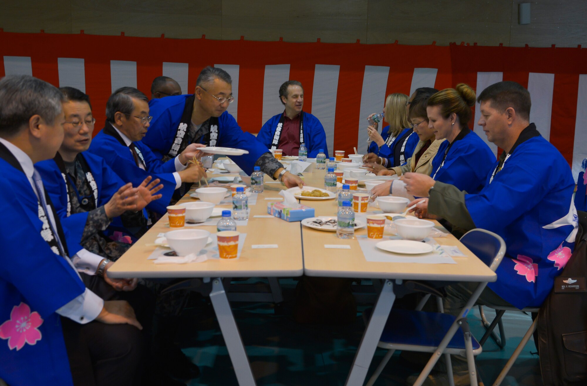 Members of the U.S. Air Force and Japan Air Self-Defense Force eat mochi during a Mochitsuki ceremony at Yokota Air Base, Japan, Dec. 10, 2015. The ceremony brought members of Yokota together to enjoy a Japanese tradition. (U.S. Air Force photo by Senior Airman David Owsianka/Released)