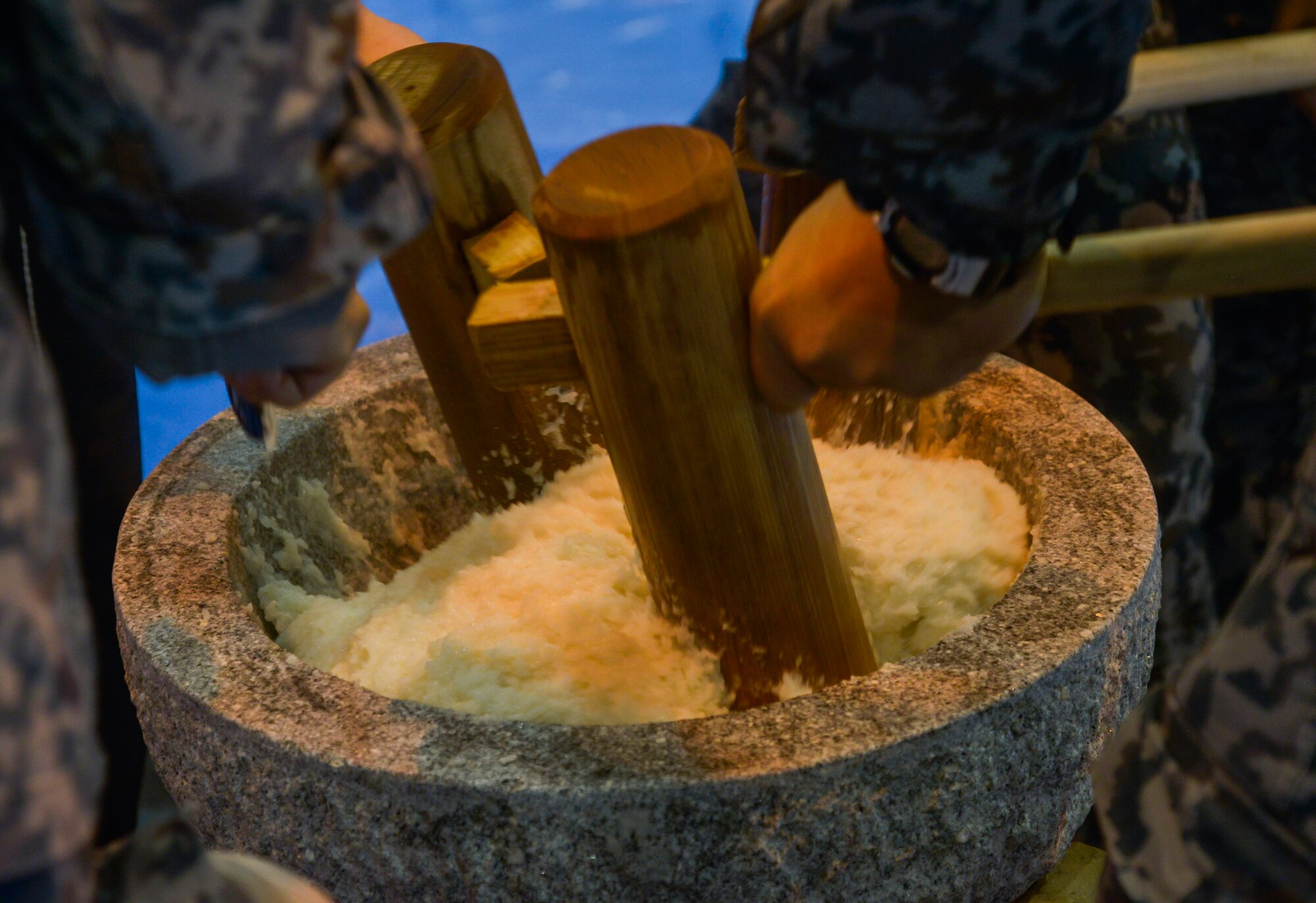 Members of the Japan Air Self-Defense Force pound rice in a stone mortar during a Mochitsuki ceremony at Yokota Air Base, Japan, Dec. 10, 2015. After the mochi is pounded, it is broken down into smaller pieces and formed into various shapes. (U.S. Air Force photo by Senior Airman David Owsianka/Released)