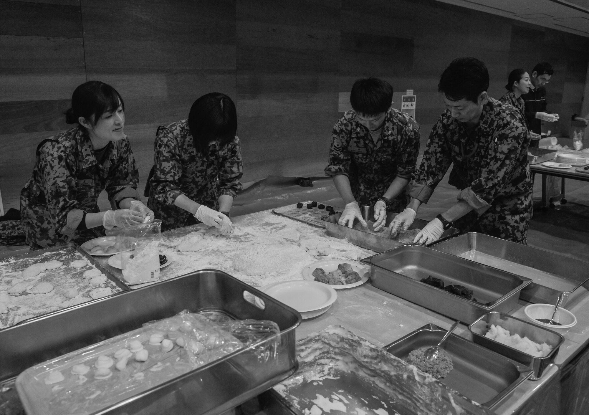 Members of the U.S. Air Force and Japan Air Self-Defense Force mold mochi into different forms during a Mochitsuki ceremony at Yokota Air Base, Japan, Dec. 10, 2015. Sweets, sugars or toasted soy bean powder are often added to mochi prior to being consumed. (U.S. Air Force photo by Senior Airman David Owsianka/Released)