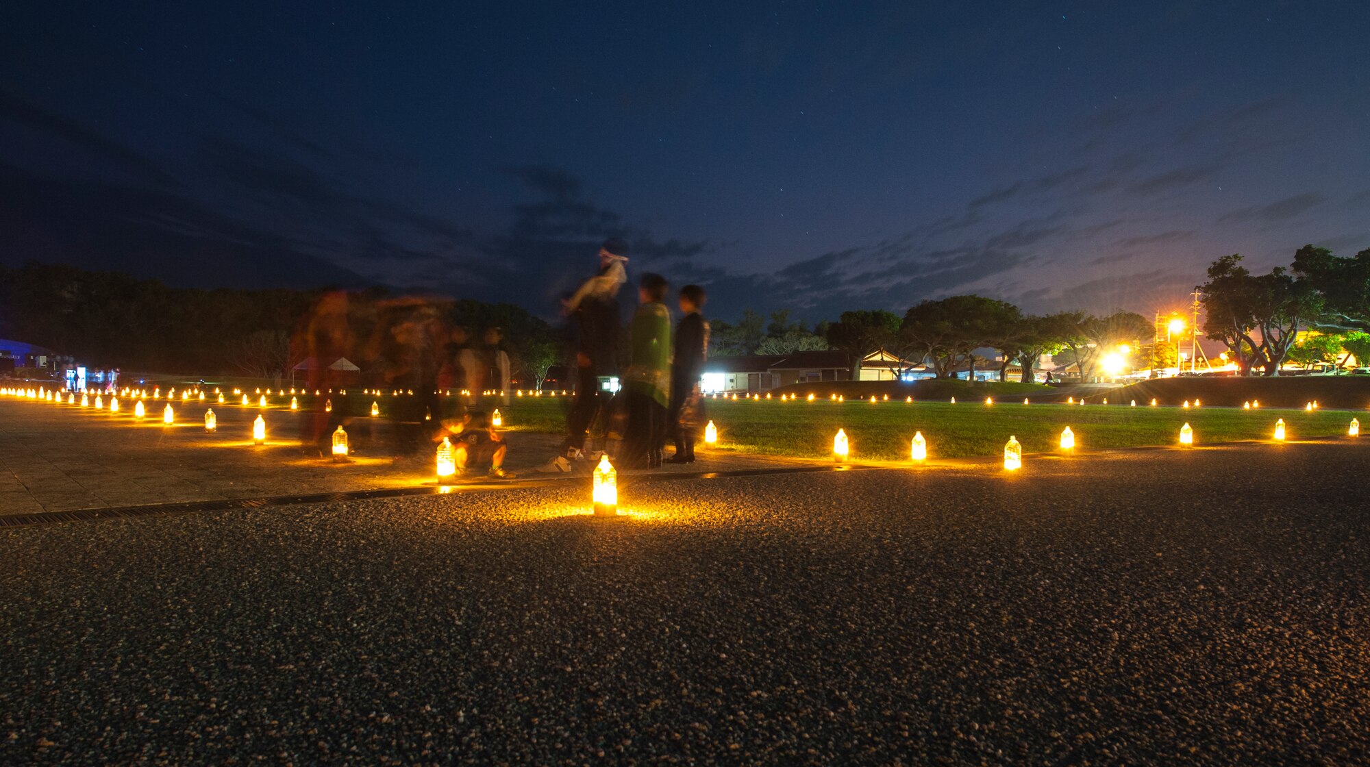 Americans and Okinawans walk along the lantern path during the Heart of Peace Festival, Dec. 12, 2015, at the Okinawan Prefectural Prayer Park in Okinawa, Japan. The Heart of Peace Festival is held to honor those who perished in the Pacific War. (U.S. Air Force photo by Airman 1st Class Nicholas Emerick)