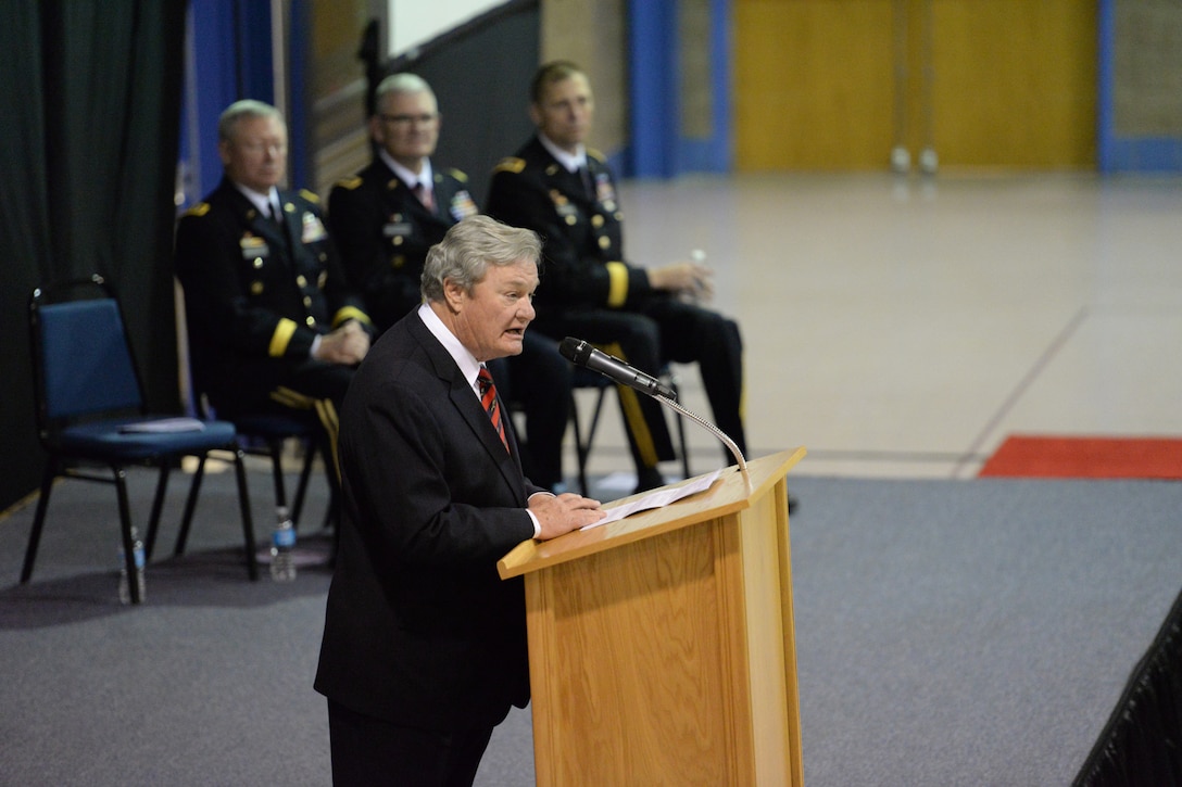 North Dakota Gov. Jack Dalrymple speaks to and audience at the North Dakota adjutant general change of command ceremony as Maj. Gen. Al Dohrmann, the in-coming North Dakota adjutant general, seated on far right, Maj. Gan. David Sprynczynatyk, the retiring North Dakota adjutant general, second from right, and Gen. Frank Grass, chief of the National Guard Bureau, look on at the Raymond J. Bohn Armory, Bismarck, North Dakota, Dec. 13, 2015. (U.S. Air National Guard photo by Senior Master Sgt. David H Lipp/Released)