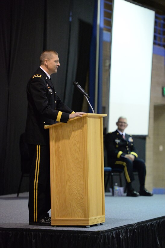 U.S. Army Maj. Gen. Al Dohrmann, the in-coming North Dakota adjutant general, left, speaks to an audience as Maj. Gen. David Sprynczynatyk, the out-going North Dakota adjutant general, far right, looks on during their change of command ceremony at the Raymond J. Bohn Armory, Bismarck, North Dakota, Dec. 13, 2015. (U.S. Air National Guard photo by Senior Master Sgt. David H Lipp/Released)