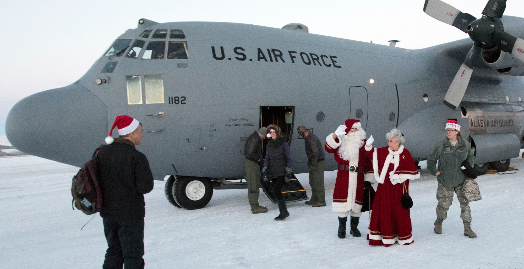 ST. MARY'S, Alaska -- Santa Claus and Mrs. Claus wave as they exit an Alaska Air National Guard C-130 here Dec. 5, 2015. The Clauses were here as part of Operation Santa Claus, a nonprofit organization partnered with the Alaska National Guard to collect toys, school supplies and food staples and deliver them to school children in Alaska's remote  communities. This mission was the second and final Op Santa mission of 2015. St. Mary's was the site of the original Operation Santa Claus in 1957. (U.S. Air National Guard photo by Capt. John Callahan/ Released)