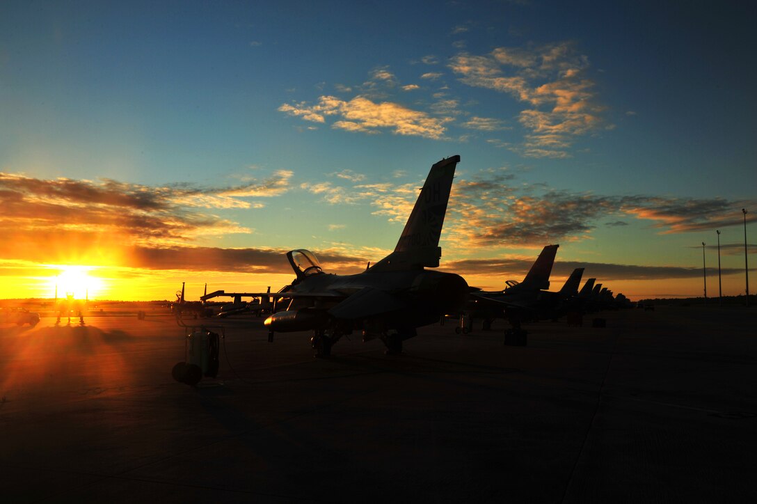 An F-16 Fighting Falcon from the 180th Fighter Wing sits on the flightline at Tyndall Air Force Base, Fla., Sept. 18, before morning sorties. About 120 Airmen from the 180th FW traveled to Tyndall Air Force Base, Fla., to participate in the Combat Archer exercise, a weapons system evaluation program designed to test the effectiveness of our Airmen and air-to-air weapon system capability of our F-16s and other combat aircraft. Training allows our pilots to provide a vital link for the defense of our country. Air National Guard photo by Senior Master Sgt. Beth Holliker/Released 

