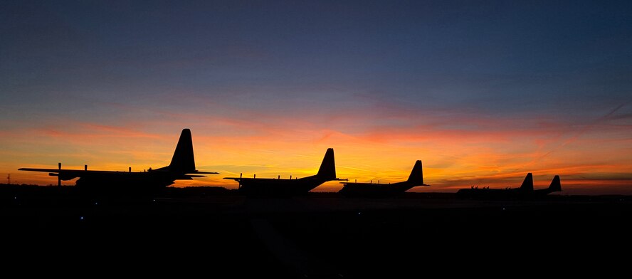 C-130 Hercules aircraft from the 182nd and 86th Airlift Wings rest on an apron in Powidz, Poland, Oct. 29, 2015. The wings participated in bilateral training with the Polish air force during Aviation Detachment 16-1 as part of Operation Atlantic Resolve’s mission to foster joint readiness while building interoperability. (Photo courtesy of Tech. Sgt. Joel Sluis/Released)