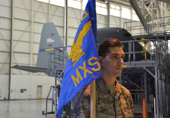 U.S. Air Force Staff Sgt. Lexington Darocy holds the guidon for the 145th Maintenance Group during a promotion ceremony held in honor of Lt. Col. Karen Shook, commander of the 145th Aircraft Maintenance Squadron. The event was held inside the C-130 maintenance hangar at the North Carolina Air National Guard Base, Charlotte Douglas International Airport, Nov. 11, 2015. (U.S. Air National Guard photo by Master Sgt. Patricia F. Moran, 145th Public Affairs/Released)