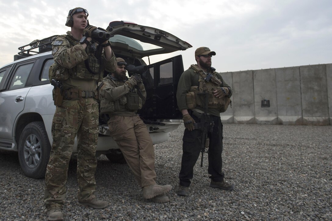 U.S. Air Force Capt. Ryan Kiggins, left, and other personnel observe as personal security detail members zero-in their weapons at a range near Kabul, Afghanistan, Dec. 8, 2015. Zeroing weapons is crucial for accurate marksmanship. Kiggens is a security forces member assigned to the Train, Advise, Assist Command-Air . U.S. Air Force photo by Staff Sgt. Corey Hook