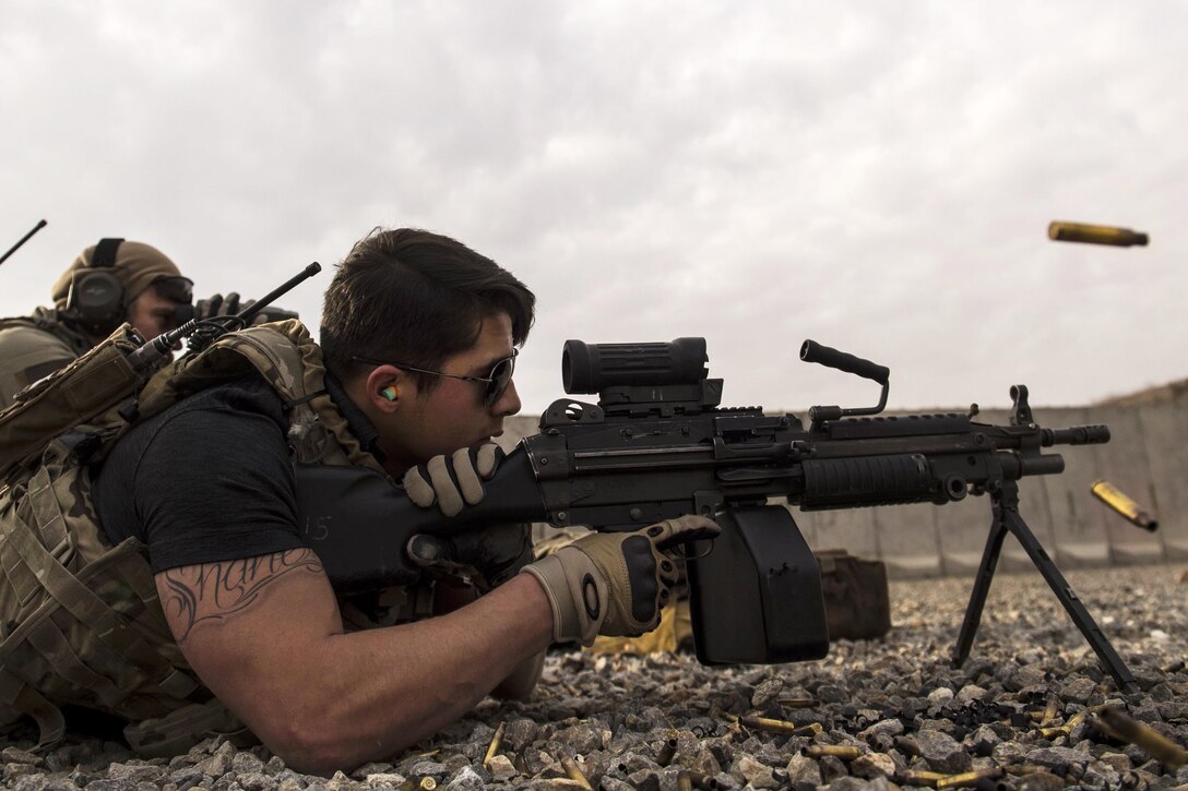 U.S. Army Spc. Jacob Ryder fires an M240 machine gun at a range near Kabul, Afghanistan, Dec. 8, 2015. Ryder is a personal security detail member assigned to the Train, Advise, Assist Command-Air security forces. U.S. Air Force photo by Staff Sgt. Corey Hook