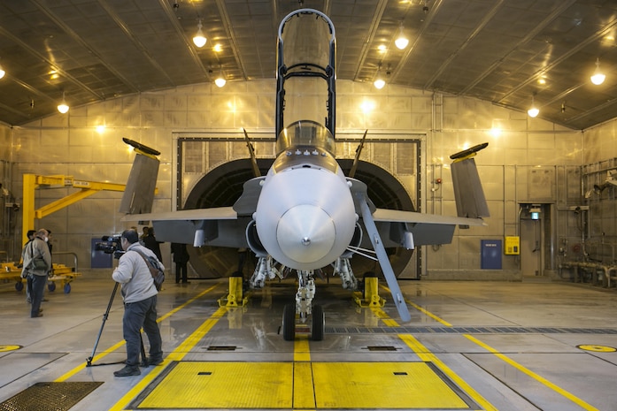 Marine Aviation Logistics Squadron 12 set up a Marine All-Weather Fighter Attack Squadron 242 F/A-18D Hornet in a Hush House at Marine Corps Air Station Iwakuni, Japan, to give Japanese press from the Yamaguchi area a demonstration of an engine test Dec. 14, 2015. These facilities are used to reduce noise in the local area when testing aircraft engines. Building and using facilities like these help strengthen the bond between the air station and the local community by showing that the station listens to the needs of the community and are doing their best to accommodate local citizens.