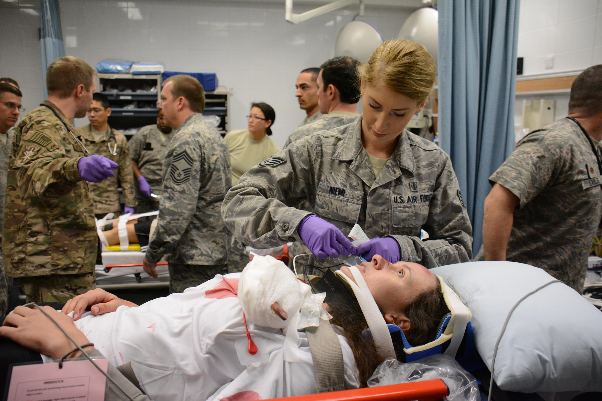 Staff Sgt. Brittany Niemi, 379th Expeditionary Medical Operations Squadron, provides care for a victim of a mock car accident in the Blatchford-Preston Complex Clinic during an exercise at Al Udeid Air Base, Qatar Dec. 15. All patients were transported to the clinic where they received emergency medical treatment. More than 50 first responders participated in the exercise. (U.S. Air Force photo by Tech. Sgt. James Hodgman/Released)