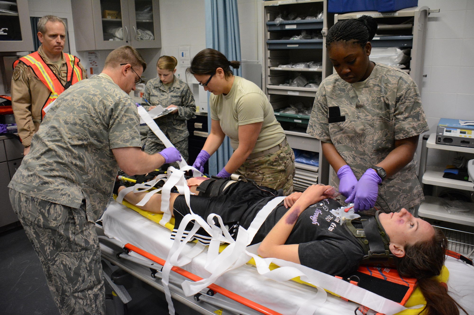 A team of medical professionals care for a victim of a mock car accident in the Blatchford-Preston Complex Clinic during an exercise at Al Udeid Air Base, Qatar Dec. 15. The exercise consisted of a car accident with eight victims. All patients were transported to the clinic where they received emergency medical treatment. More than 50 first responders participated in the exercise. (U.S. Air Force photo by Tech. Sgt. James Hodgman/Released)