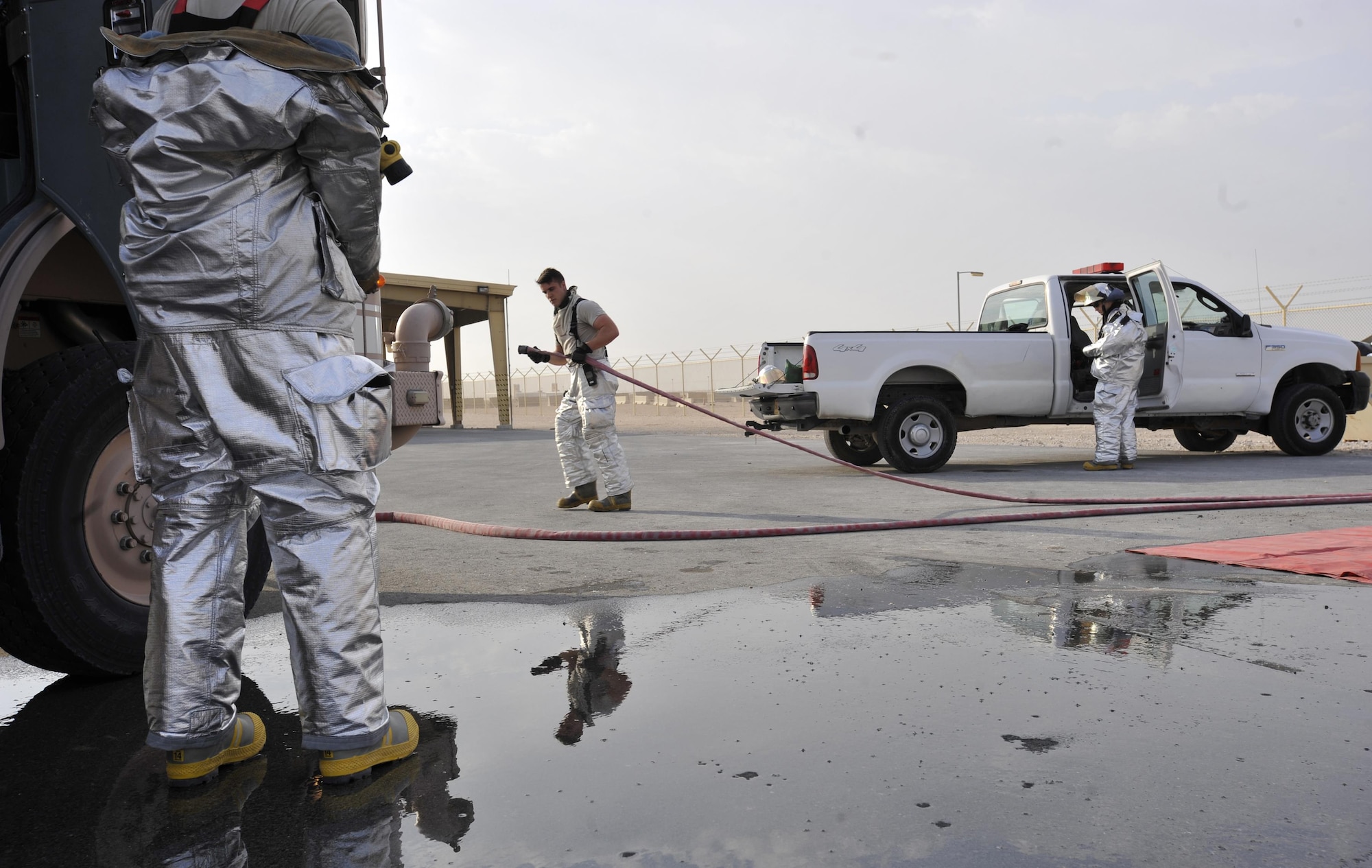 Firefighters from the 379th Expeditionary Civil Engineer Squadron, Al Udeid Air Base, Qatar put away their tools and equipment following a mass casualty exercise at AUAB, Dec. 15. The exercise tested the emergency response capabilities of fire and medical personnel. (U.S. Air Force photo by Master Sgt. Joshua Strang)