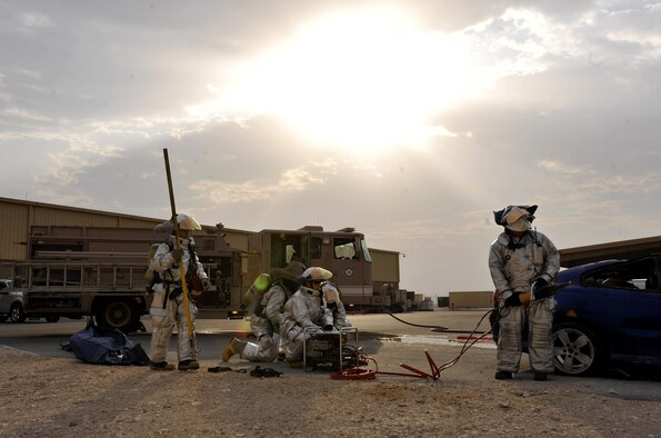 Firefighters from the 379th Expeditionary Civil Engineer Squadron, Al Udeid Air Base, Qatar prepare a hydraulic rescue tool, also known as the Jaws of Life, during a mass casualty exercise at AUAB, Dec. 15. The exercise tested the emergency response capabilities of fire and medical personnel. (U.S. Air Force photo by Master Sgt. Joshua Strang)
