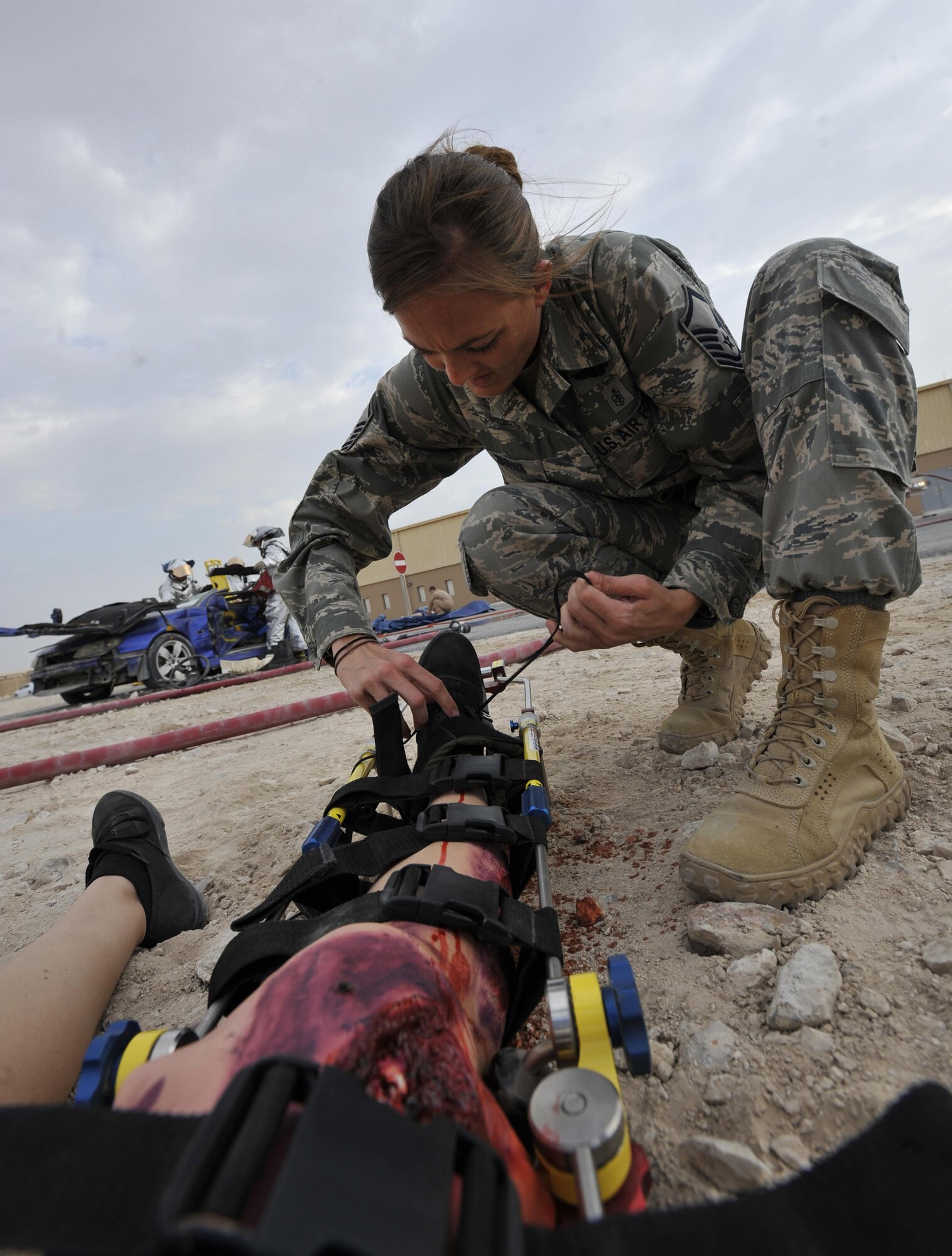 Master Sgt. Shanna Bufkin, medical technician, 340th Expeditionary Air Refueling Squadron, Al Udeid Air Base, Qatar, attends to a patient during a mass casualty exercise at Al Udeid Air Base, Qatar Dec. 15, 2015. The exercise tested the emergency response capabilities of fire and medical personnel. (U.S. Air Force photo by Master Sgt. Joshua Strang)