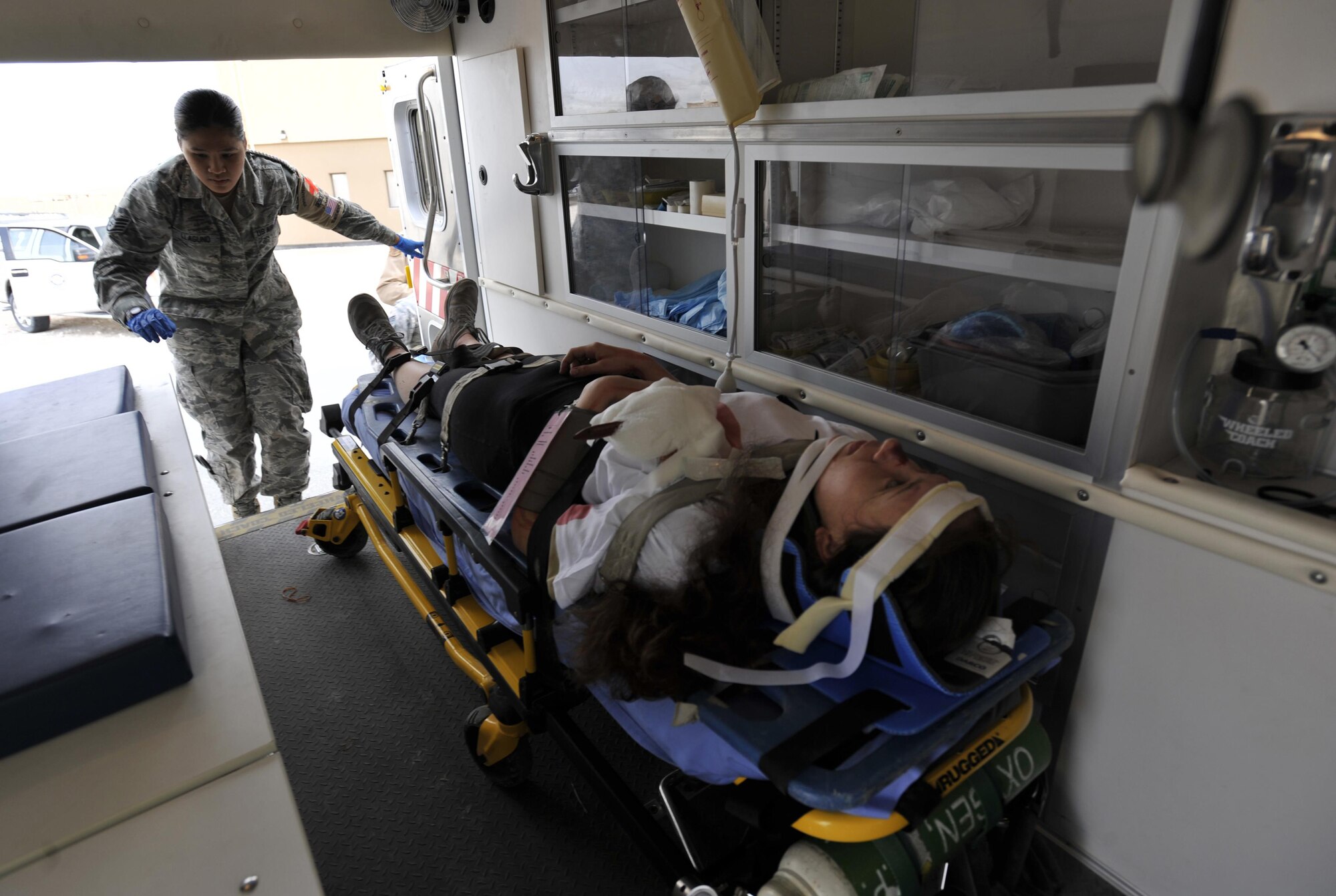 Staff Sgt. Mary Lynn Llaguno, 379th Expeditionary Medical Group, Al Udeid Air Base, Qatar, checks on a patient during a mass casualty exercise at AUAB, Dec. 15. The exercise tested the emergency response capabilities of fire and medical personnel. (U.S. Air Force photo by Master Sgt. Joshua Strang)