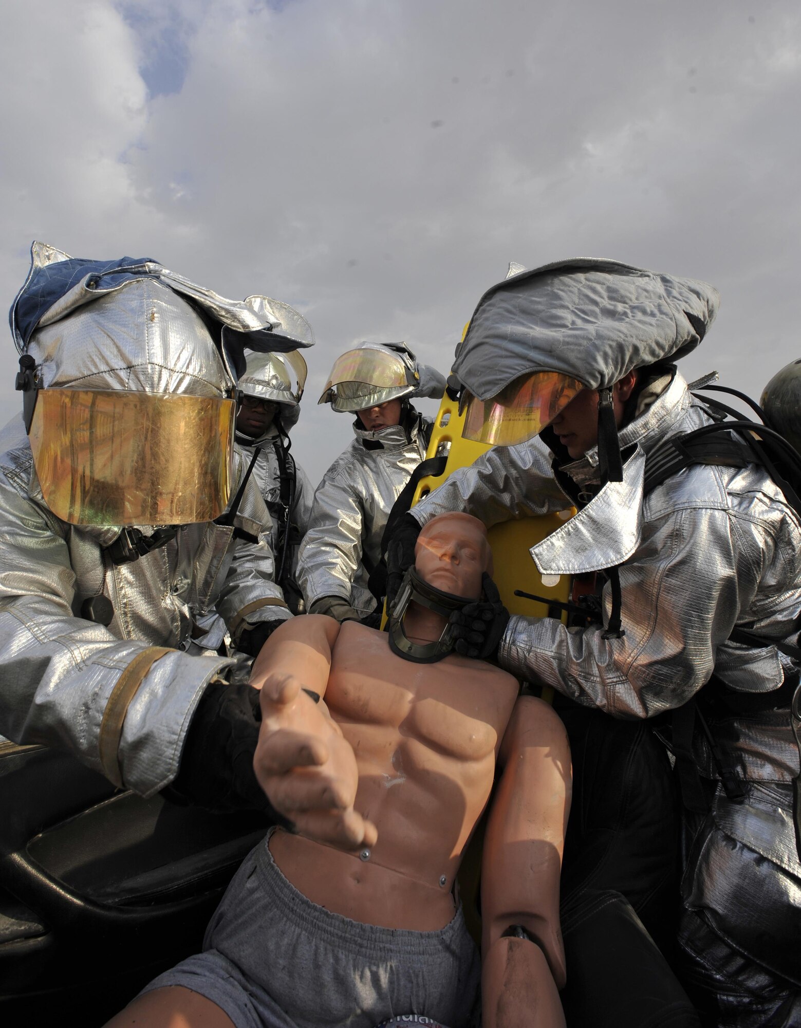 Firefighters from the 379th Air Expeditionary Civil Engineer Squadron, Al Udeid Air Base, Qatar pull a simulated patient from a vehicle during a mass casualty exercise at AUAB, Dec. 15. The exercise tested the emergency response capabilities of fire and medical personnel. (U.S. Air Force photo by Master Sgt. Joshua Strang)