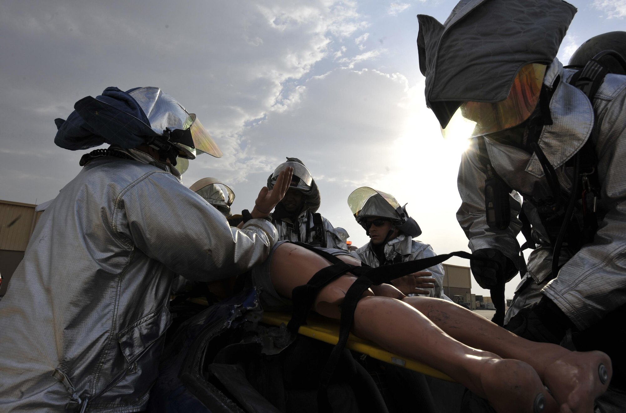 Firefighters from the 379th Expeditionary Civil Engineer Squadron, Al Udeid Air Base, Qatar pull a simulated patient from a vehicle during a mass casualty exercise at AUAB, Dec. 15. The exercise tested the emergency response capabilities of fire and medical personnel. (U.S. Air Force photo by Master Sgt. Joshua Strang)